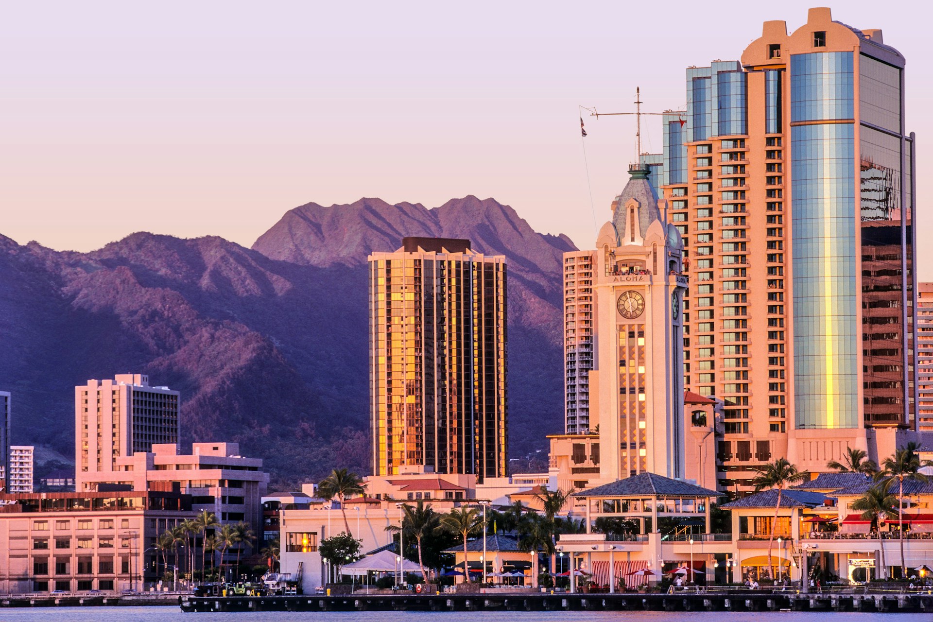 A coastal skyline under a pink sunset