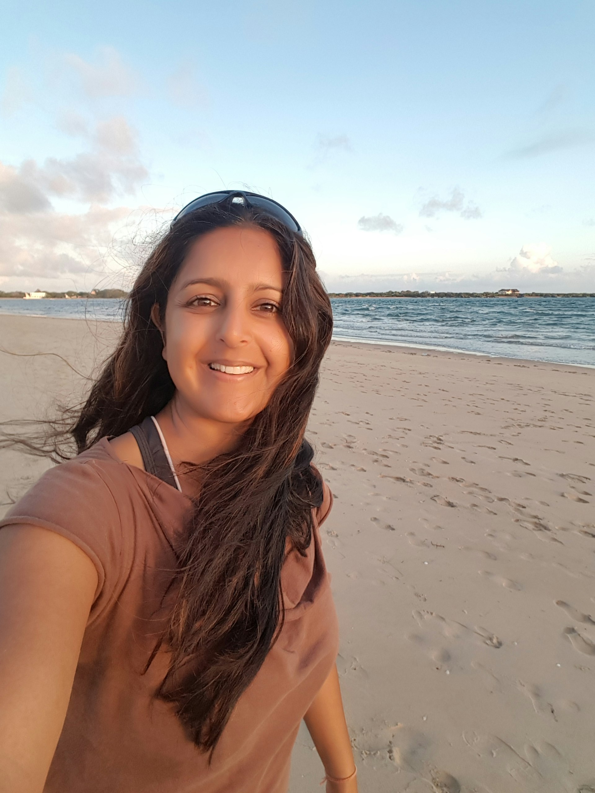 An selfie of an Asian woman on a beach