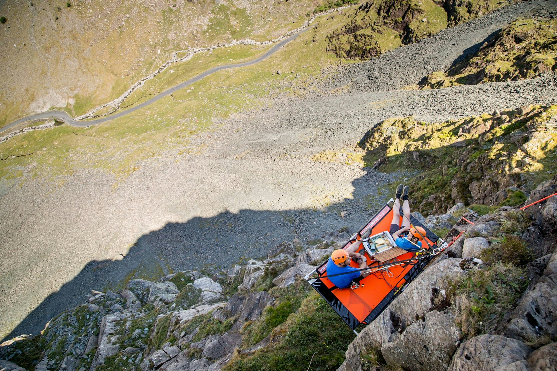 Two people camping at the side of a cliff in Cumbria