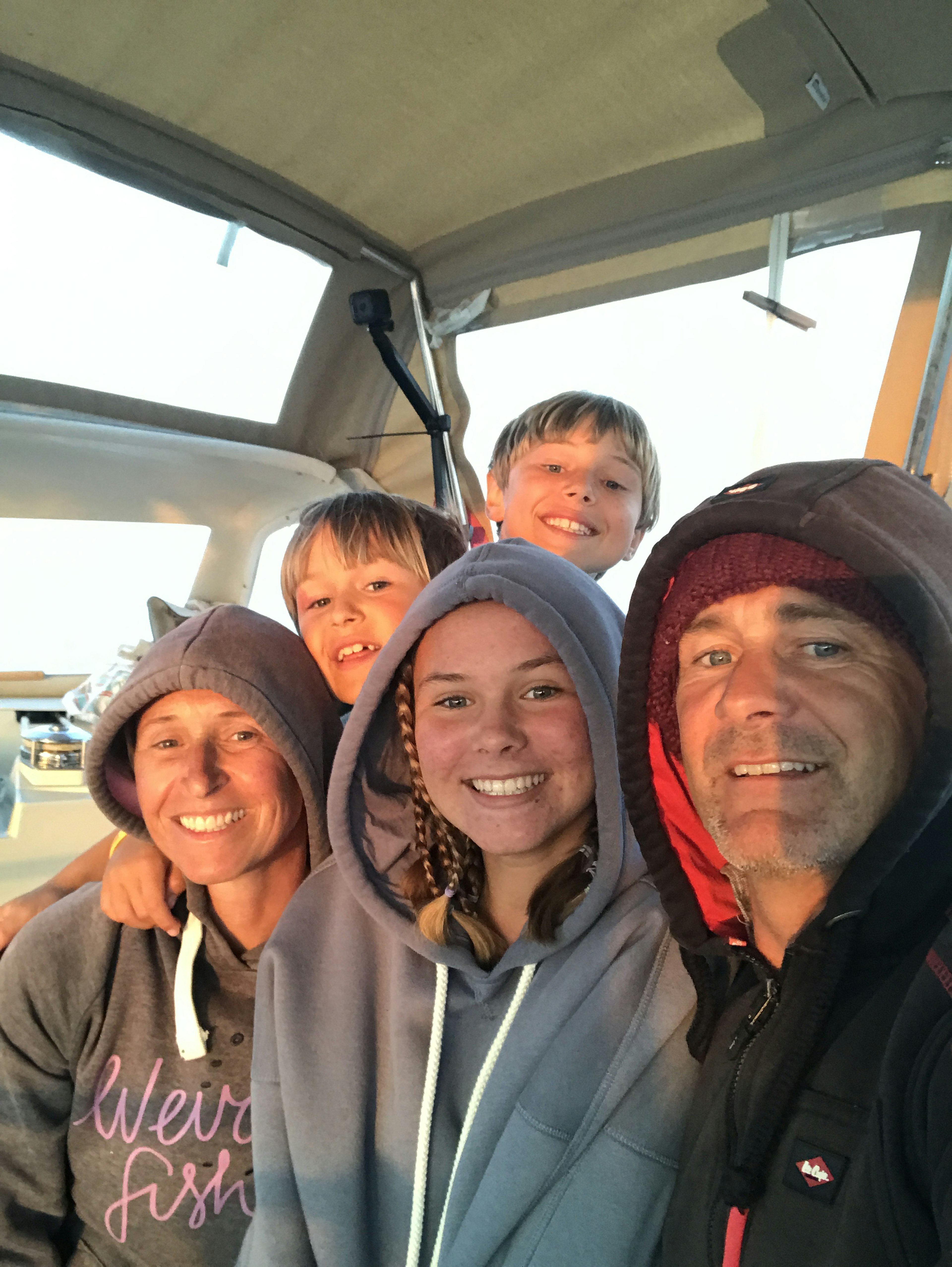 Alan and his family in the cabin on their sailing boat