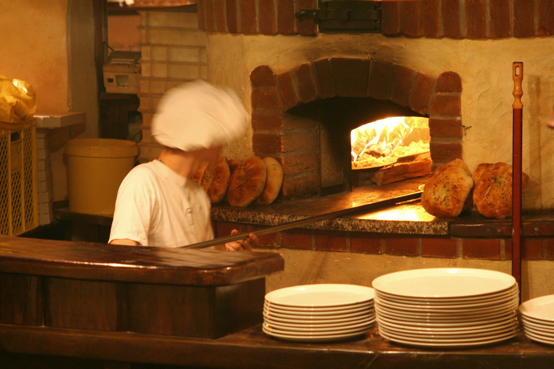 Man baking bread at Sokol restaurant in Slovenia