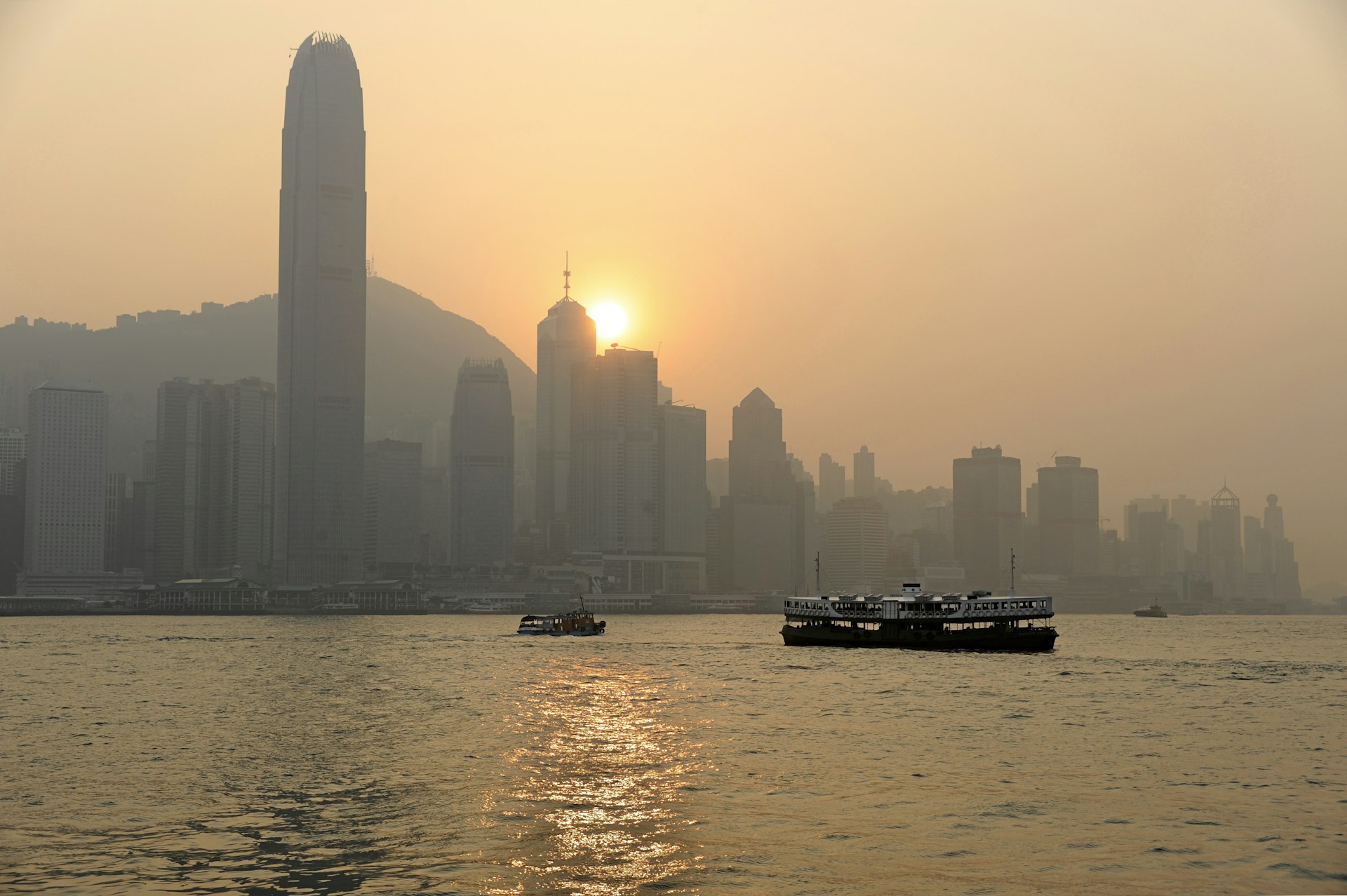 Ferry crossing Victoria Harbour at sunset
