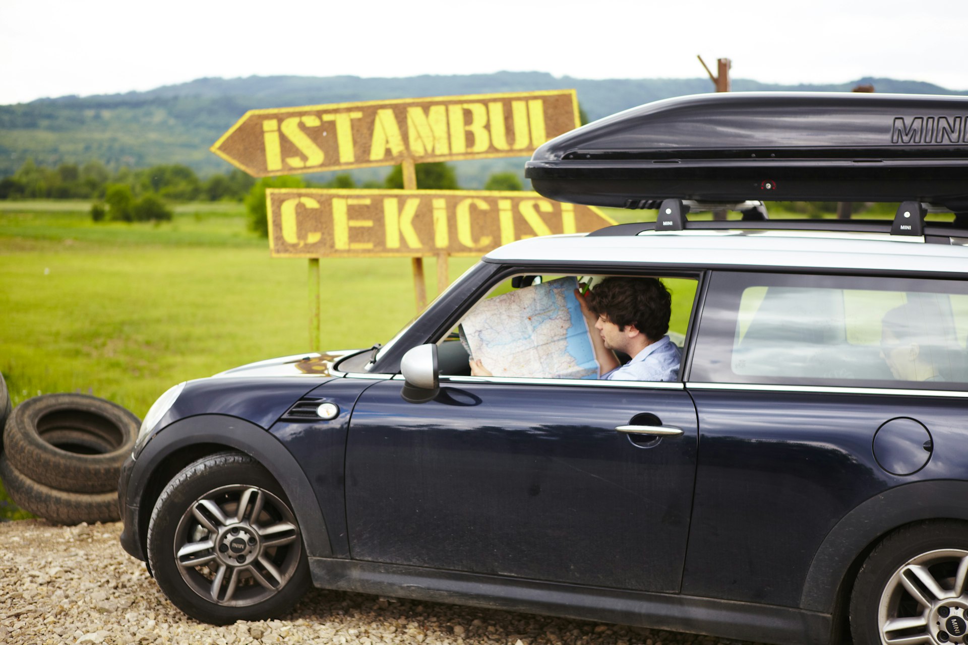 Man looking at a map inside a car