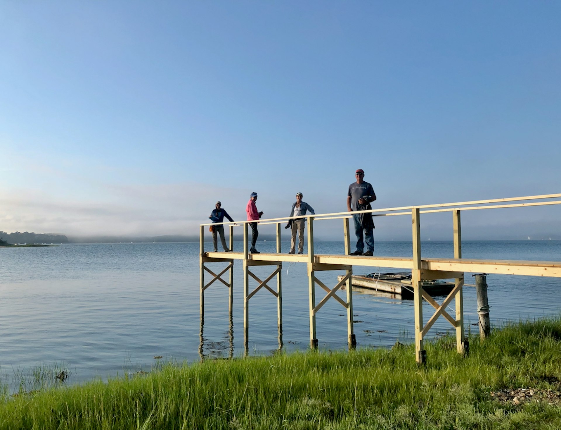 Four people on a pier on Sipson Island