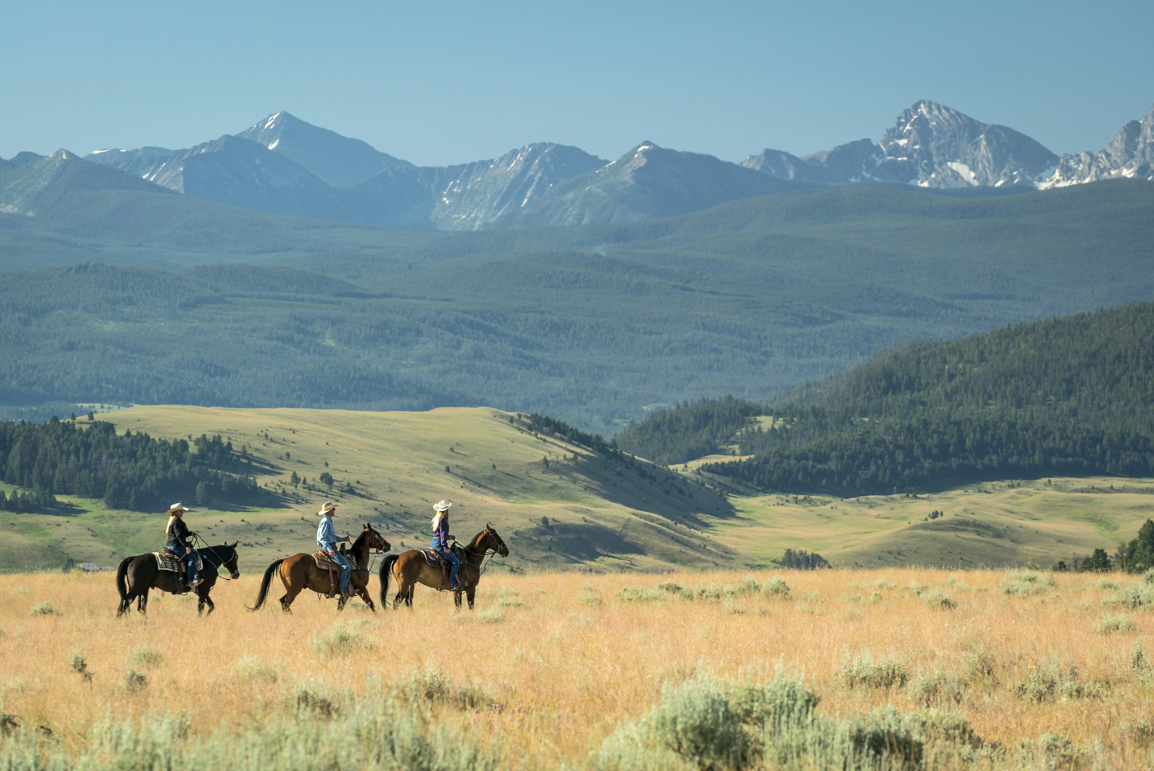 Three people on an autumn horseback ride at the Ranch at Rock Creek