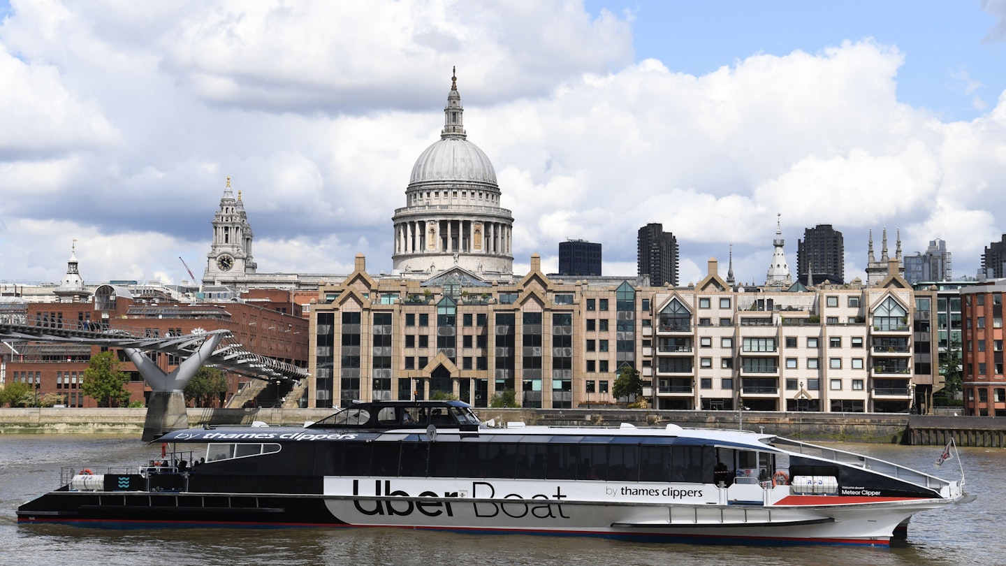 An Uber boat passes St Paul's cathedral in partnership with Thames clippers the boat tickets can be purchased via the ride hailing firm's app on August 3, 2020. (Photo by DANIEL LEAL-OLIVAS / AFP) (Photo by DANIEL LEAL-OLIVAS/AFP via Getty Images)