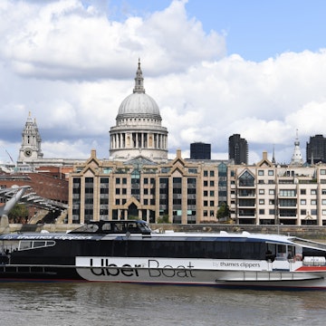An Uber boat passes St Paul's cathedral in partnership with Thames clippers the boat tickets can be purchased via the ride hailing firm's app on August 3, 2020. (Photo by DANIEL LEAL-OLIVAS / AFP) (Photo by DANIEL LEAL-OLIVAS/AFP via Getty Images)