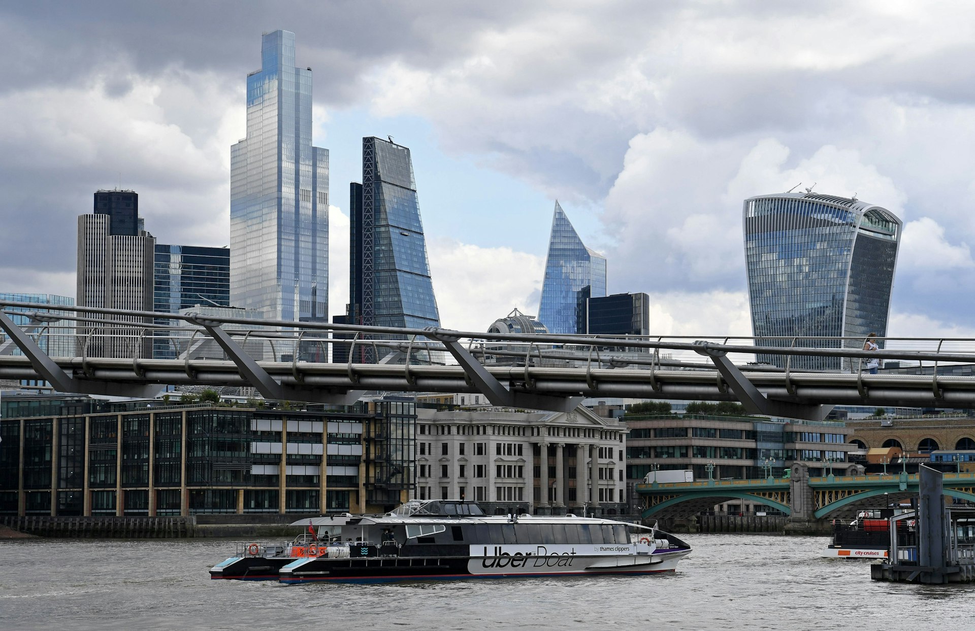 An Uber Boat river bus services crosses through the Thames in central London