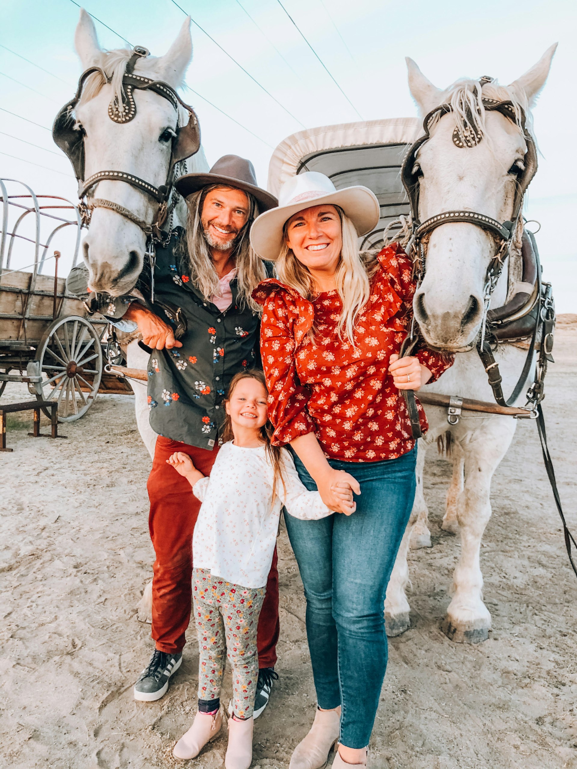 A couple and child with two horses