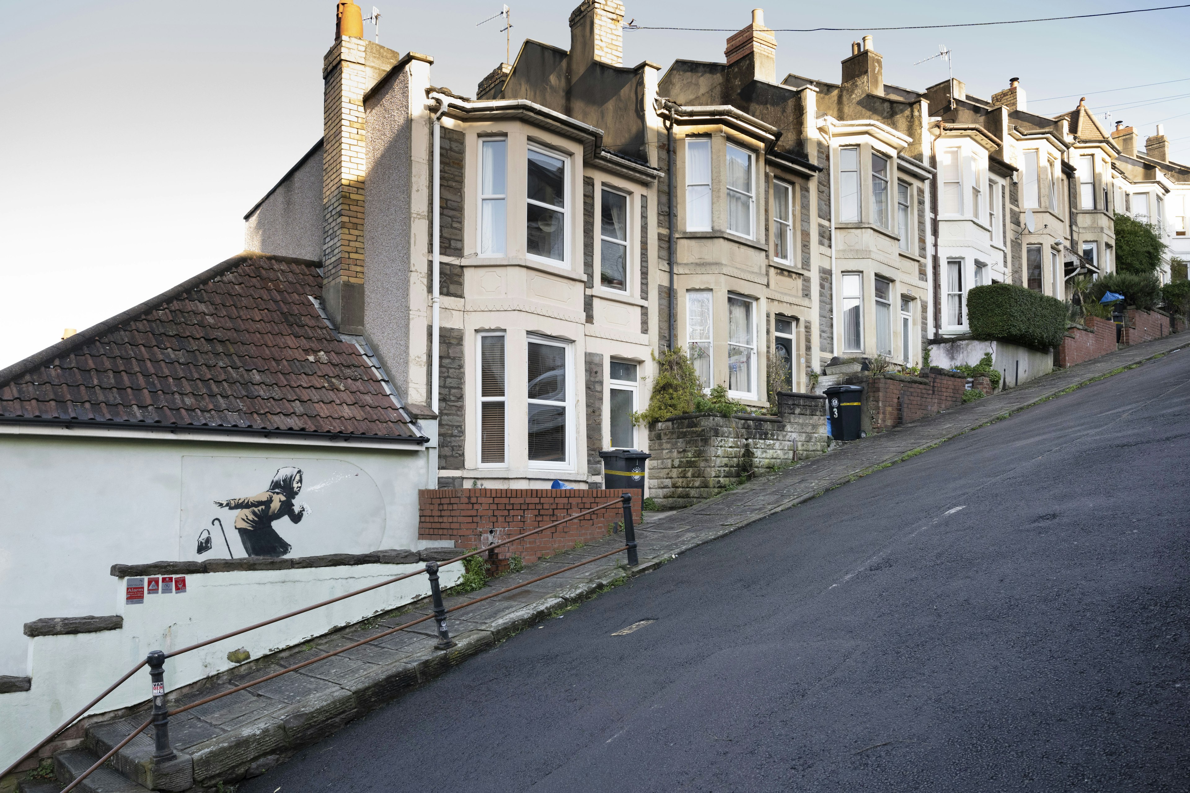 A landscape picture of the graffiti and the sloped road