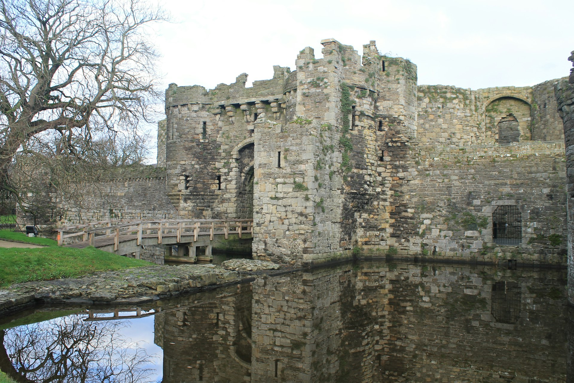 The entrance gate to Beaumaris Castle in Anglsey, a large, unfinished castle that's surrounded by a moat.