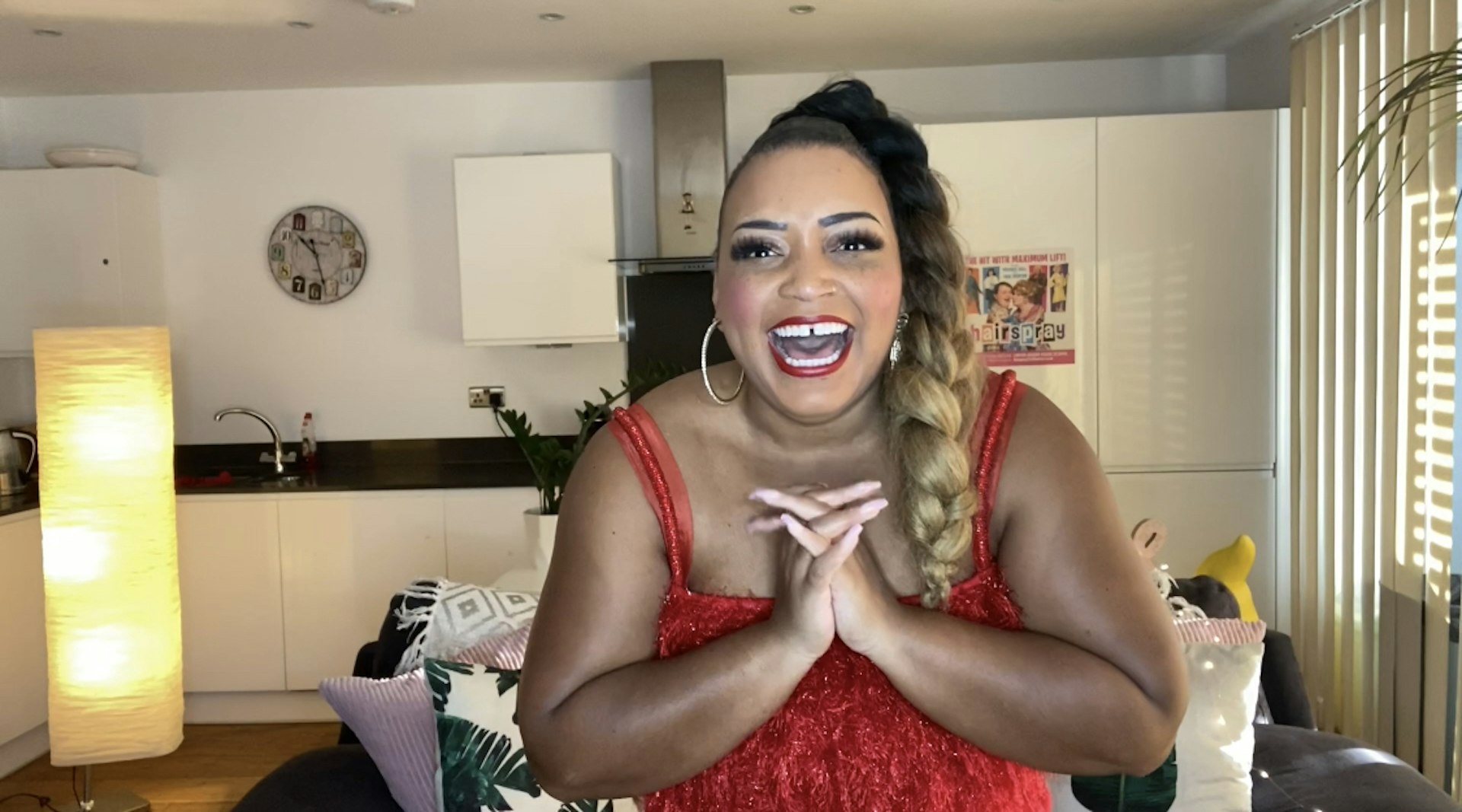 A woman smiling into the camera in her living room