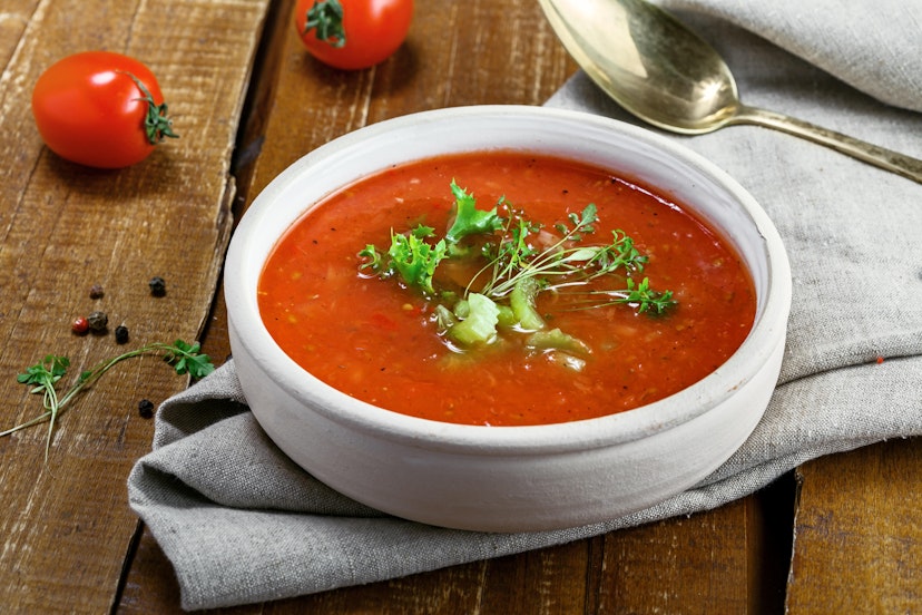 A bowl of traditional Spanish gazpacho on a rustic table.
