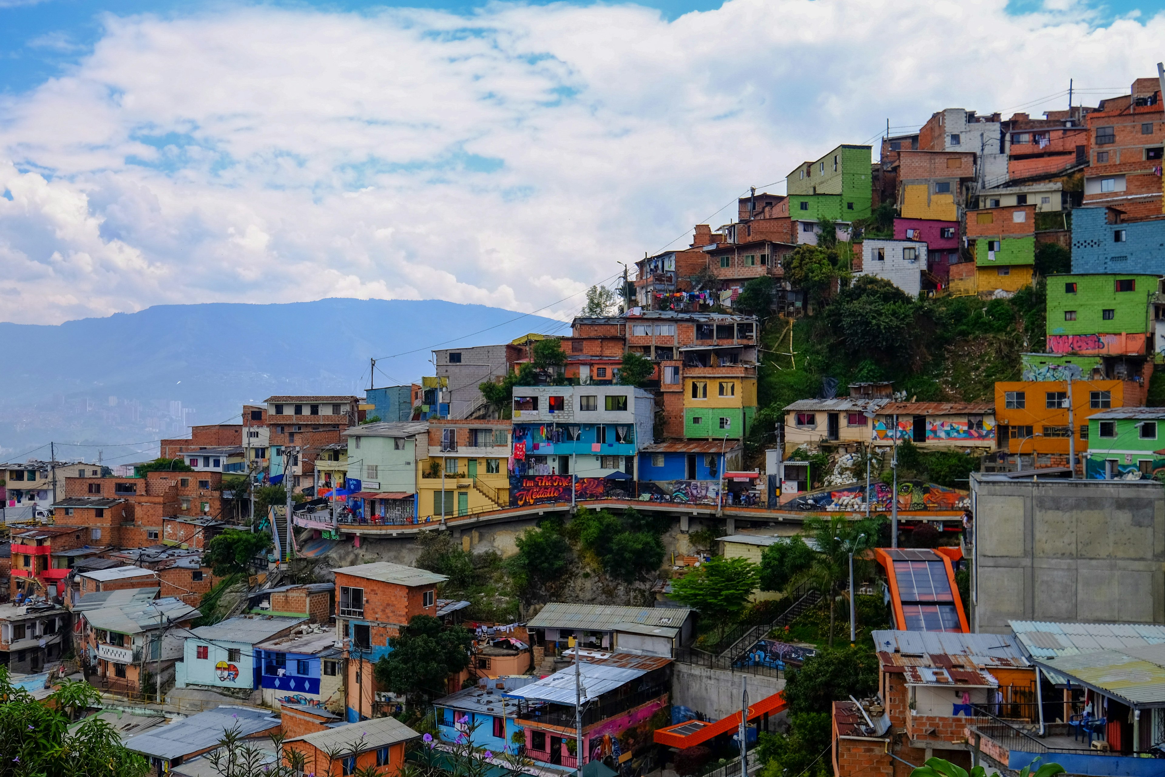 Colorful houses line a hillside in a residential area of Medellin