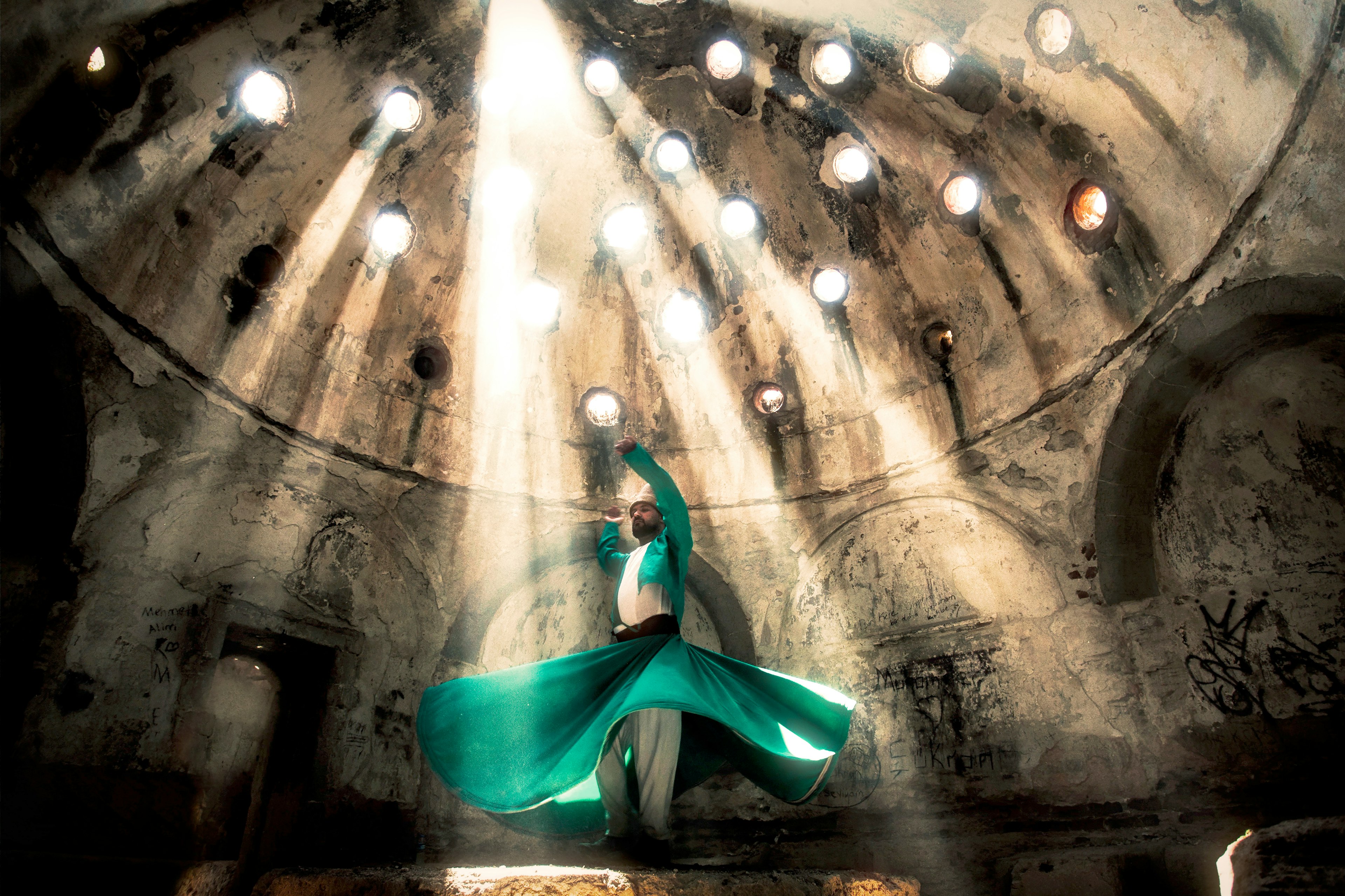 Whirling dervish under beams of sunlight in Konya