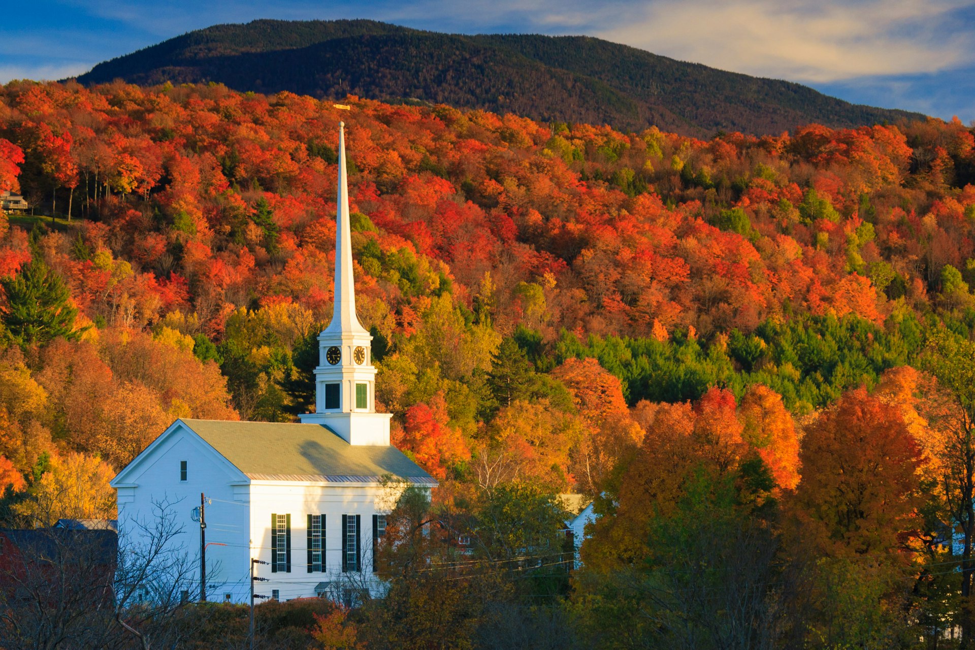 Colorful fall foliage surrounds the Stowe Community Church in Stowe, Vermont