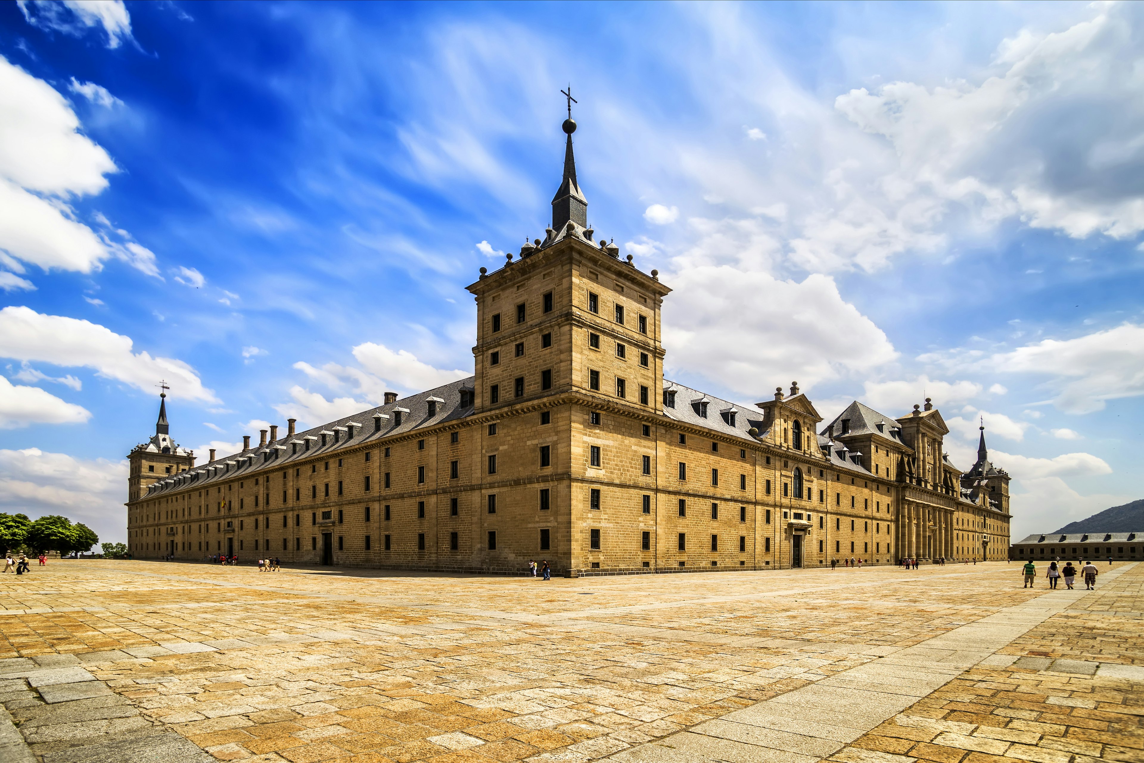 A large square monastery building in an empty square