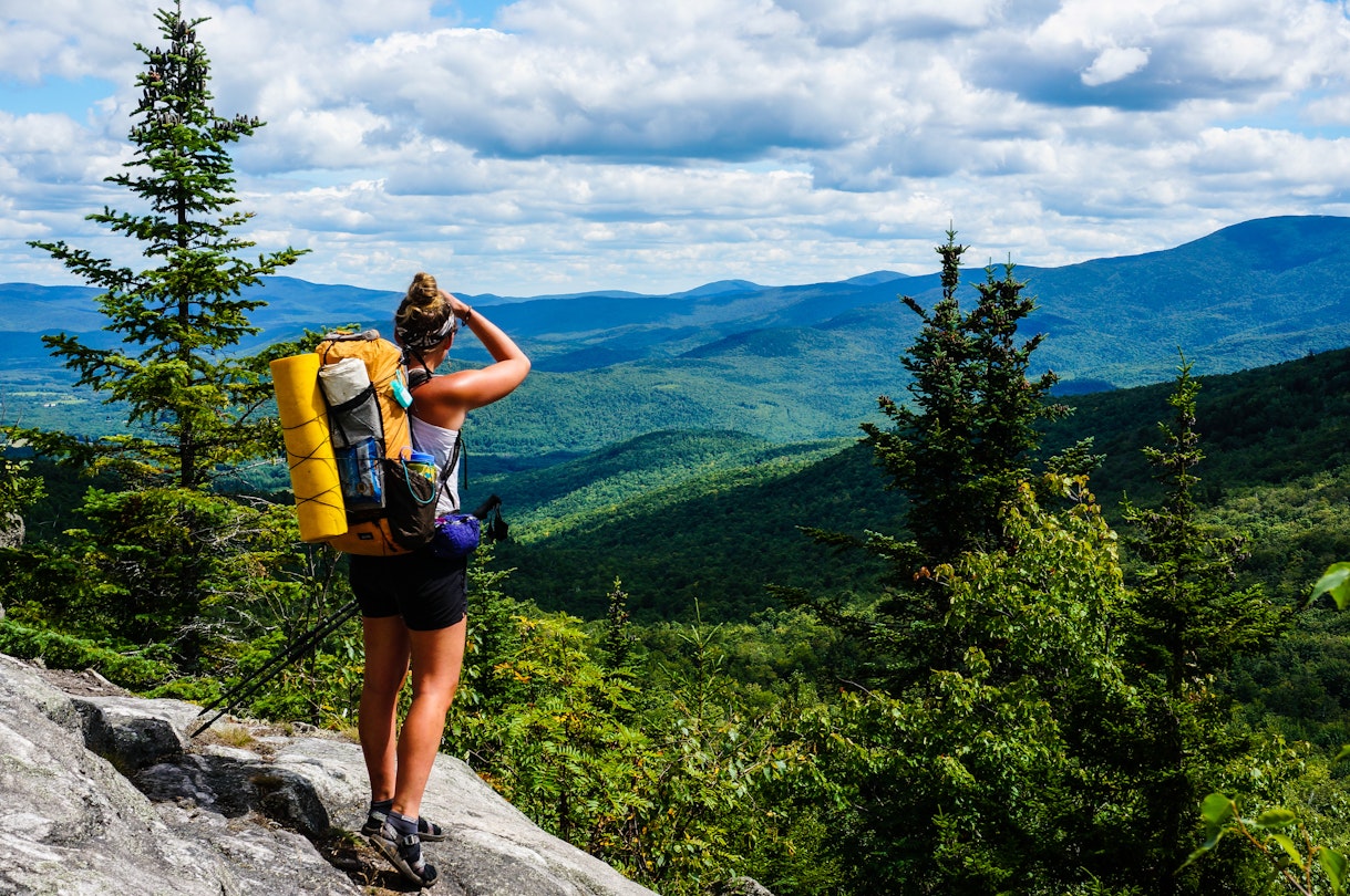 AUGUST 2015: An Appalachian Trail Thru-Hiker looks back at New Hampshire just before she crosses into Maine.