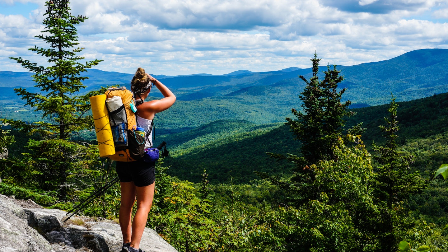 AUGUST 2015: An Appalachian Trail Thru-Hiker looks back at New Hampshire just before she crosses into Maine.
