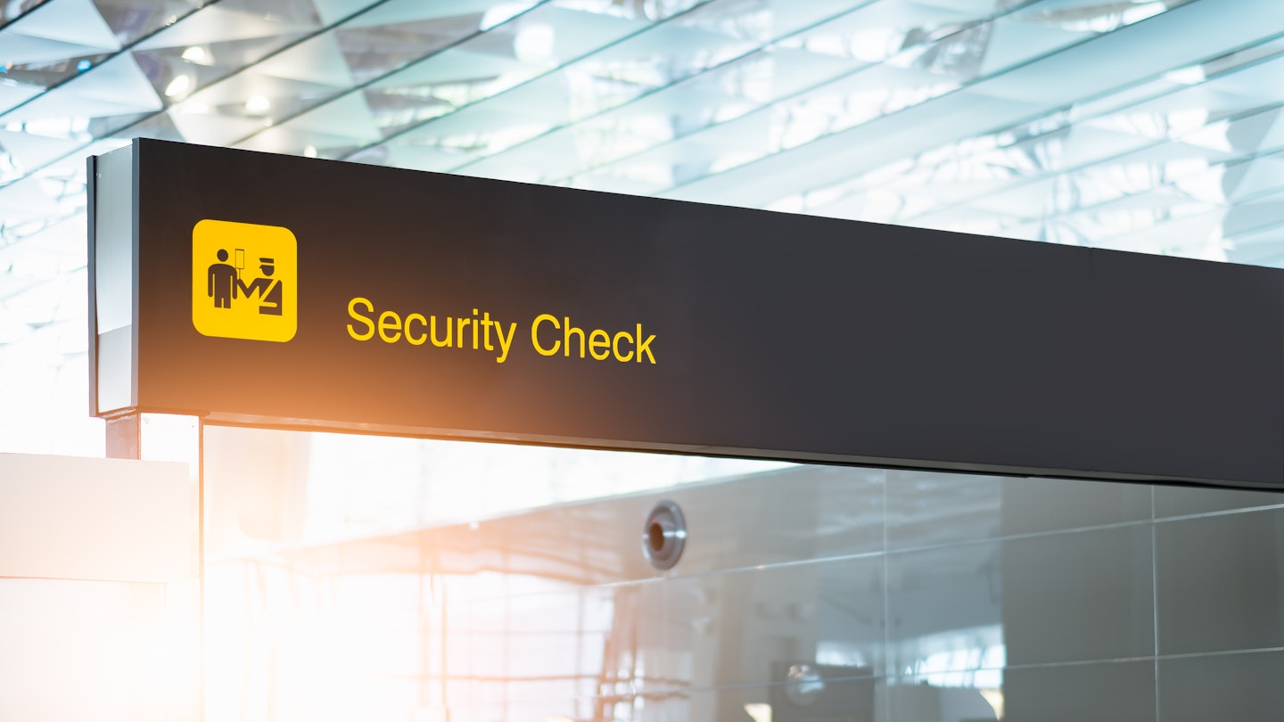 Sign for a security check at an airport.