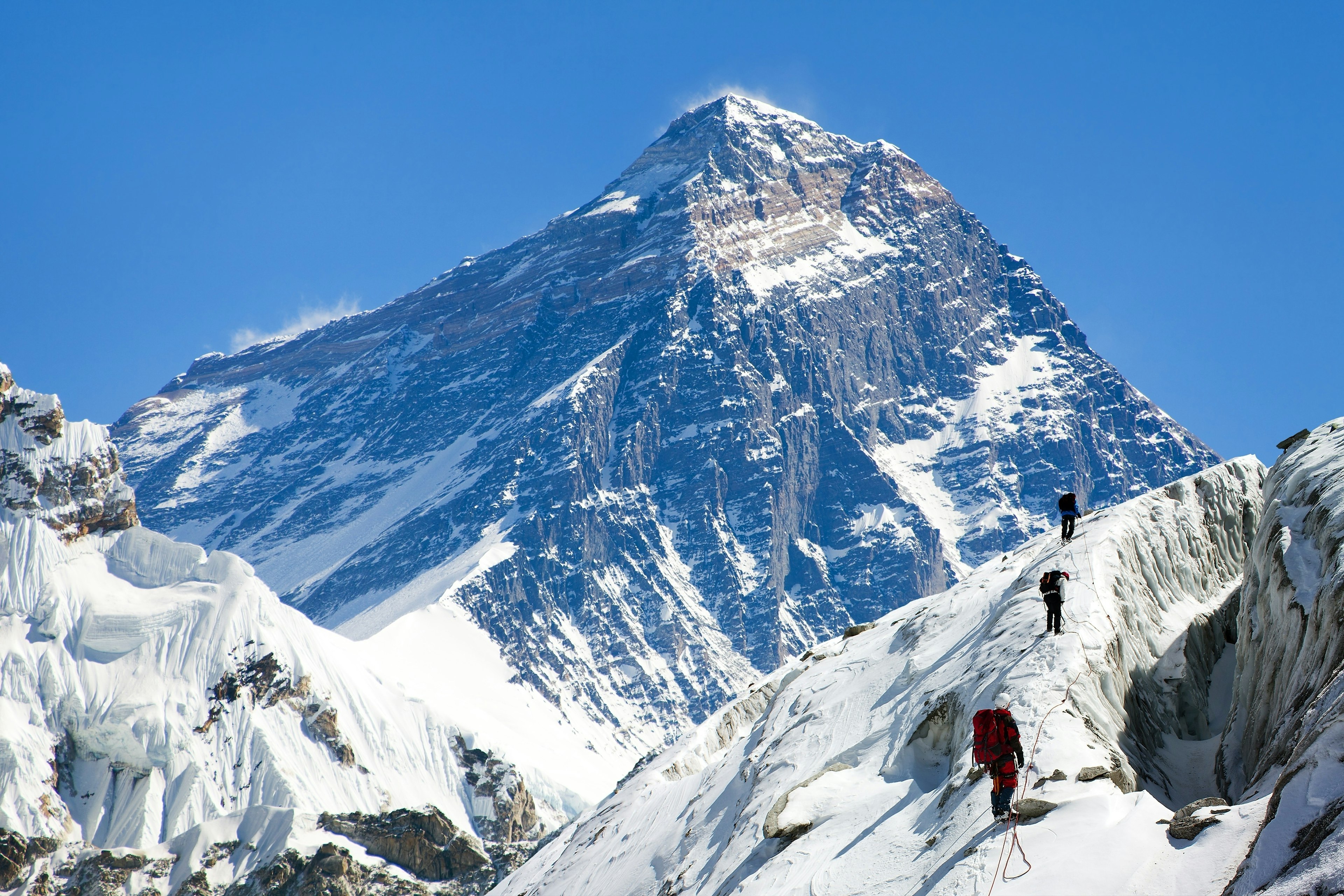 View of Everest from Gokyo valley with group of climbers on glacier