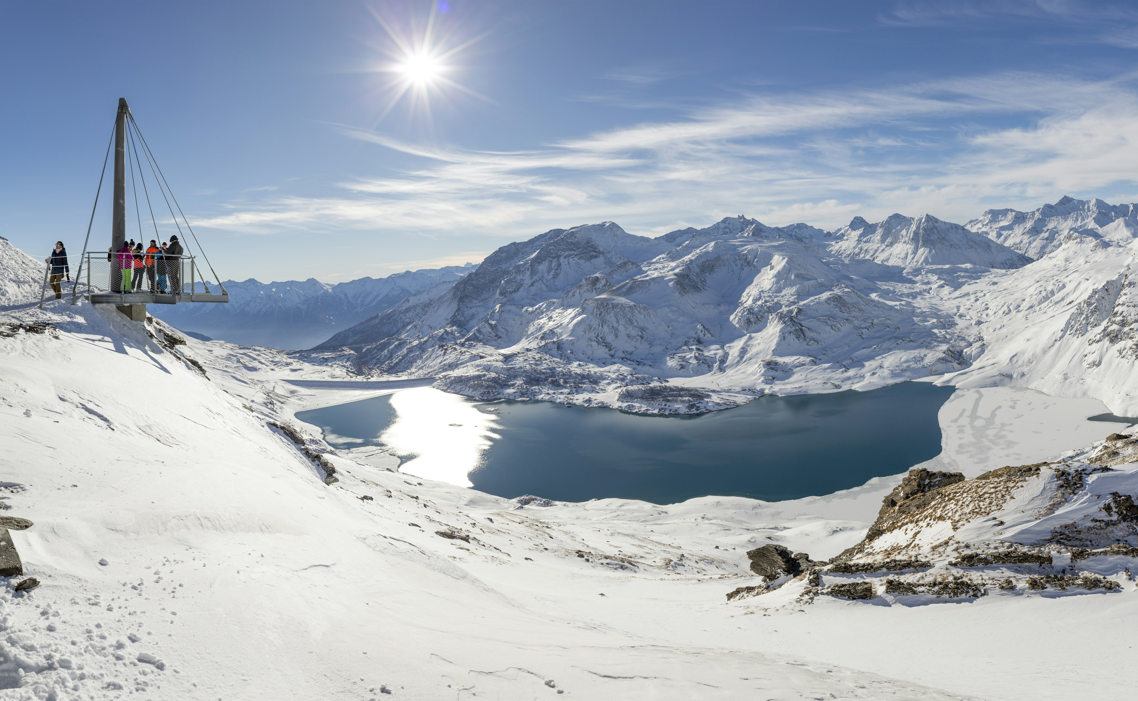 Visitors at a viewpoint looking over the French Alps