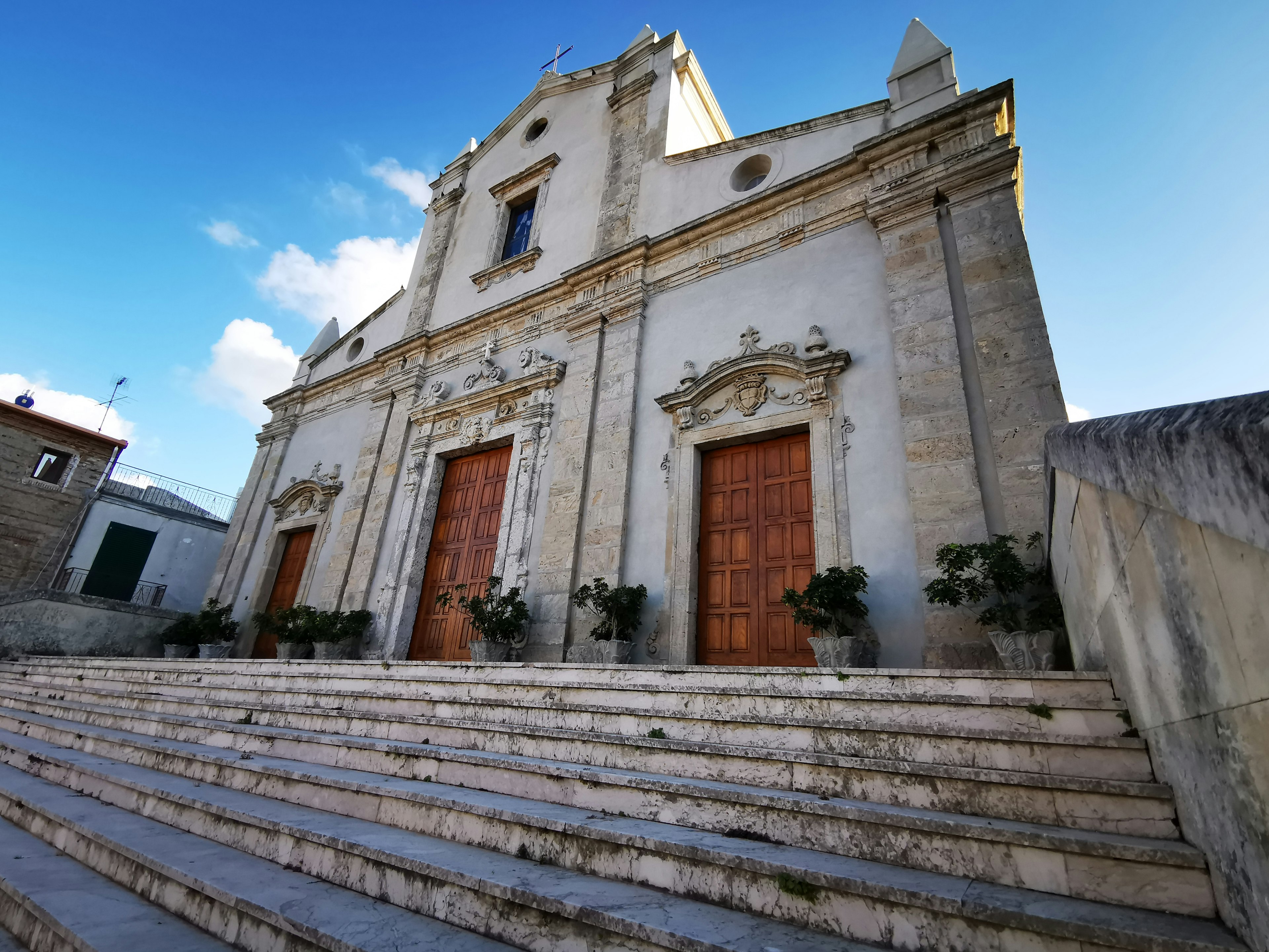 Steps leading up to an old church, with a blue sky in the background