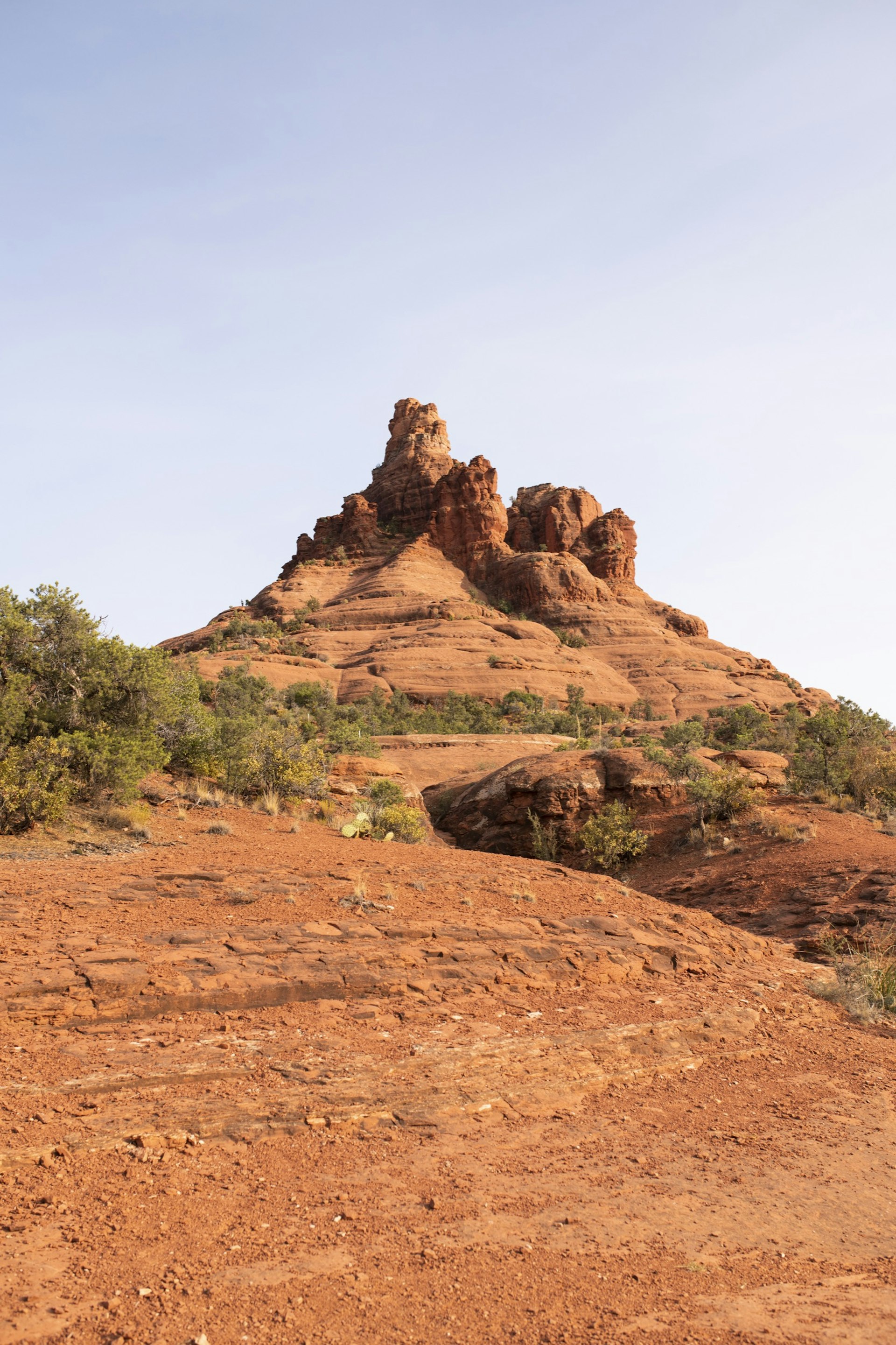 The red rocks of Bell Rock is dotted with green scrubs in Sedona 