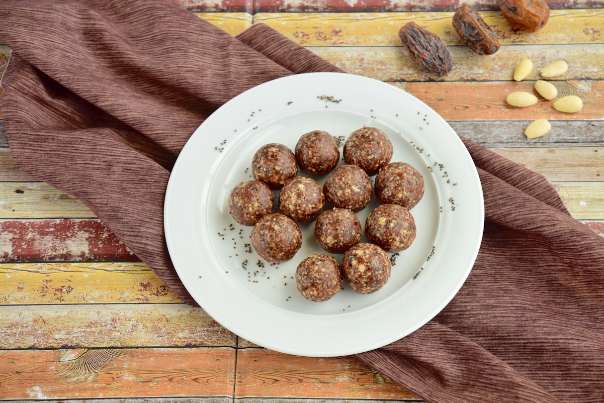 Date almond oat chia chocolate energy balls on a plate