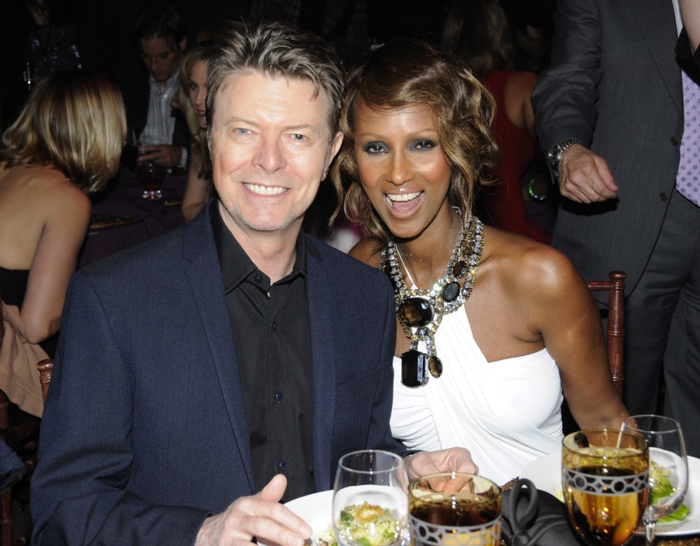 David Bowie and Iman at a table at an event