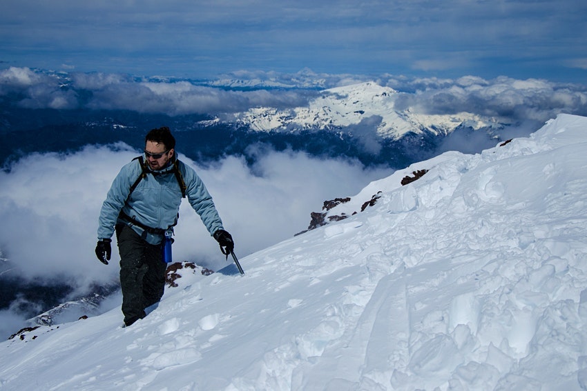 A man stands in very high snow on a mountain in Corralco, Chile 