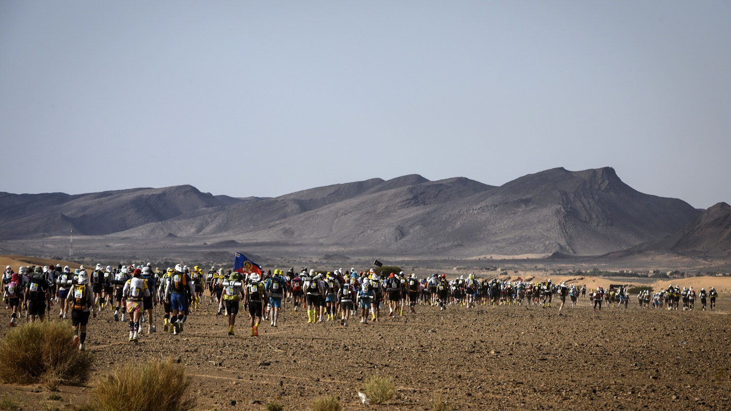 People compete in the fourth stage of the 34th edition of the Marathon des Sables between Jebel El Mraier and Rich Mbirika in the southern Moroccan Sahara desert, on April 10, 2019. - The 34th edition of the marathon is a live stage 250 kilometres race through a formidable landscape in one of the world's most inhospitable climates. (Photo by JEAN-PHILIPPE KSIAZEK / AFP)        (Photo credit should read JEAN-PHILIPPE KSIAZEK/AFP via Getty Images)
