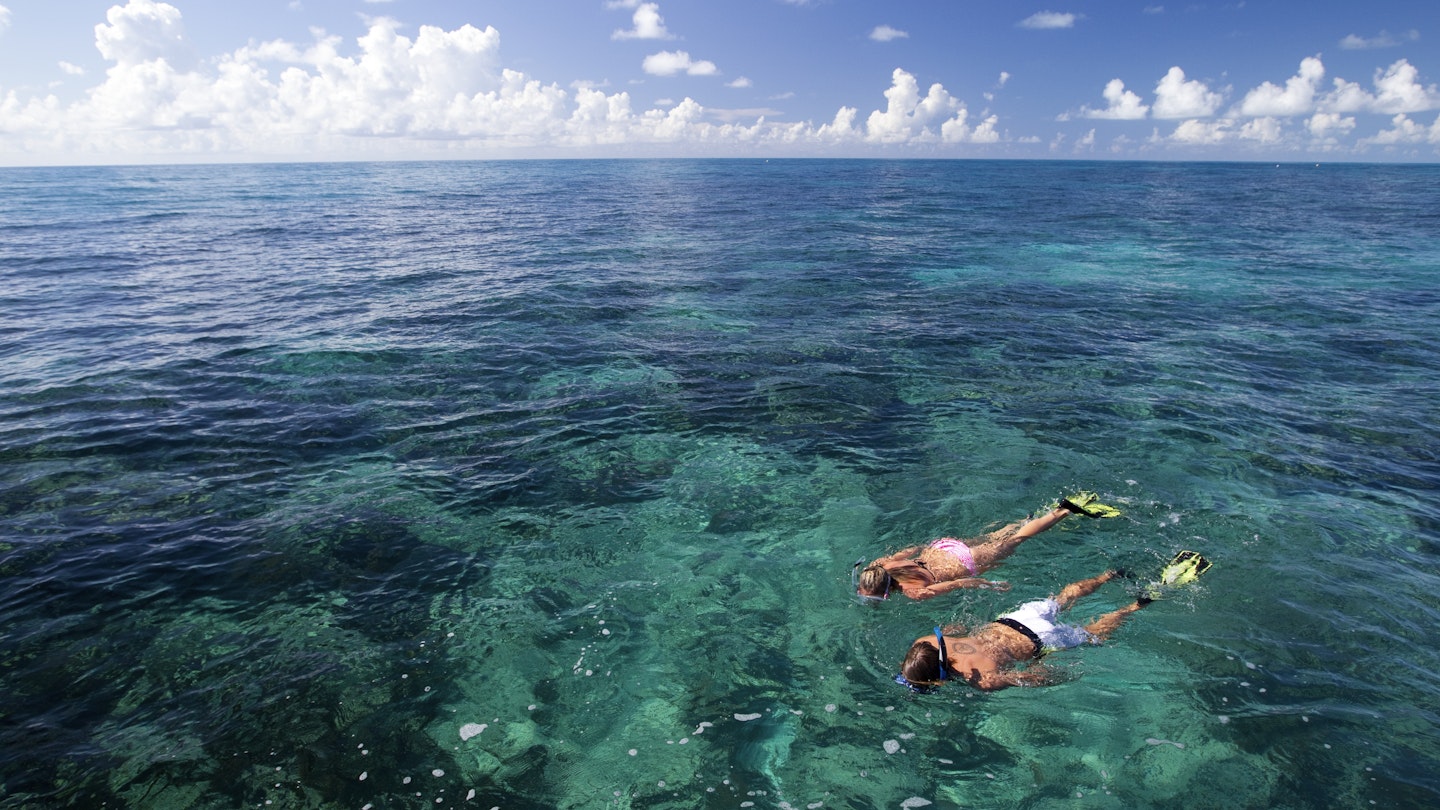 Models Cody Wagner and Katherine Wieland snorkeling at Grecian Rocks, Key Largo, a shallow reef, popular with visitors to the Florida Keys National Marine Sanctuary