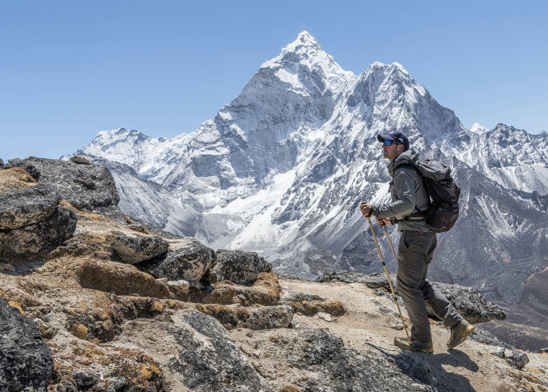 A trekker walking in a vast mountainous area
