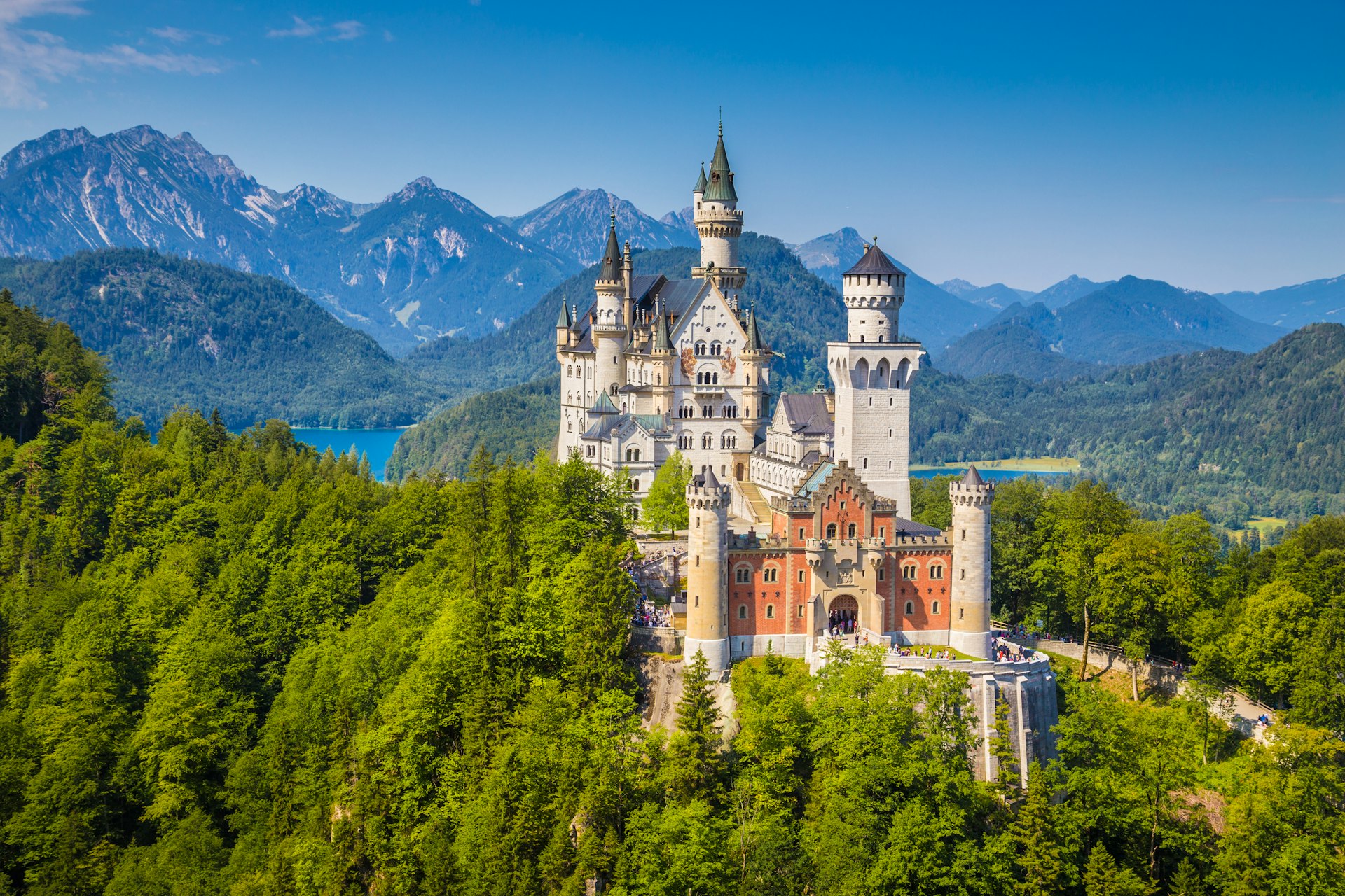 A clifftop castle surrounded by mountains and woodland