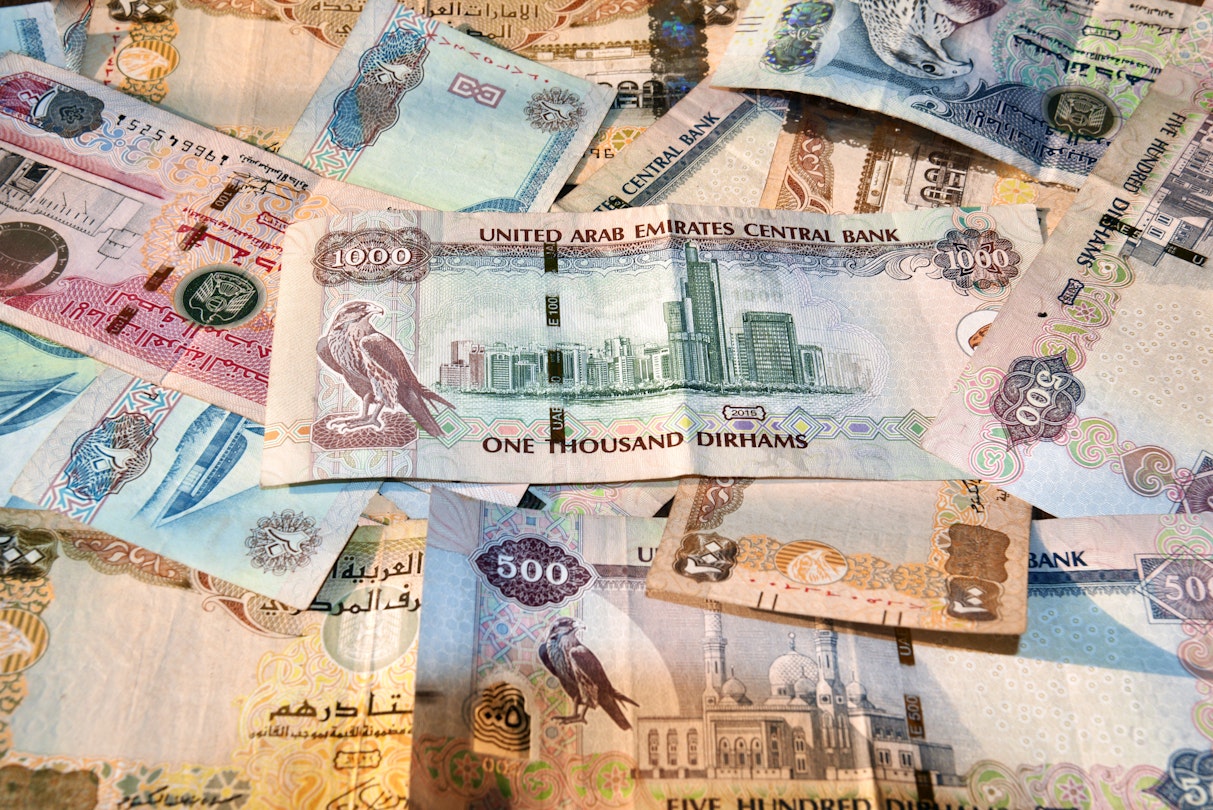 United Arab Emirates currency with notes spread on a table.