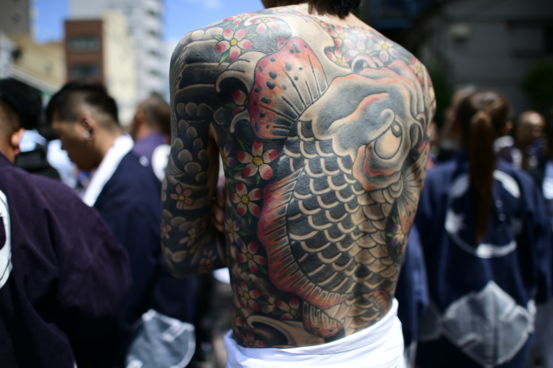 Closeup of a large Irezumi-style tattoo that covers the entire back of a man.