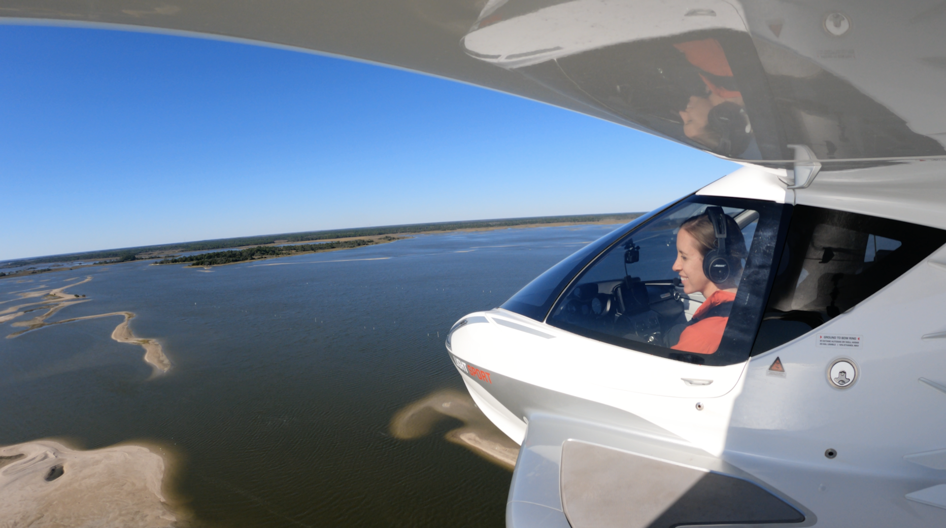 View from the wing of a small aircraft over water