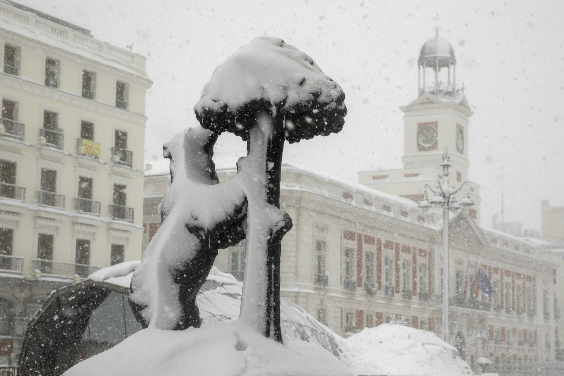 A picture of the famous bear sculpture in Puerta del Sol covered by snow