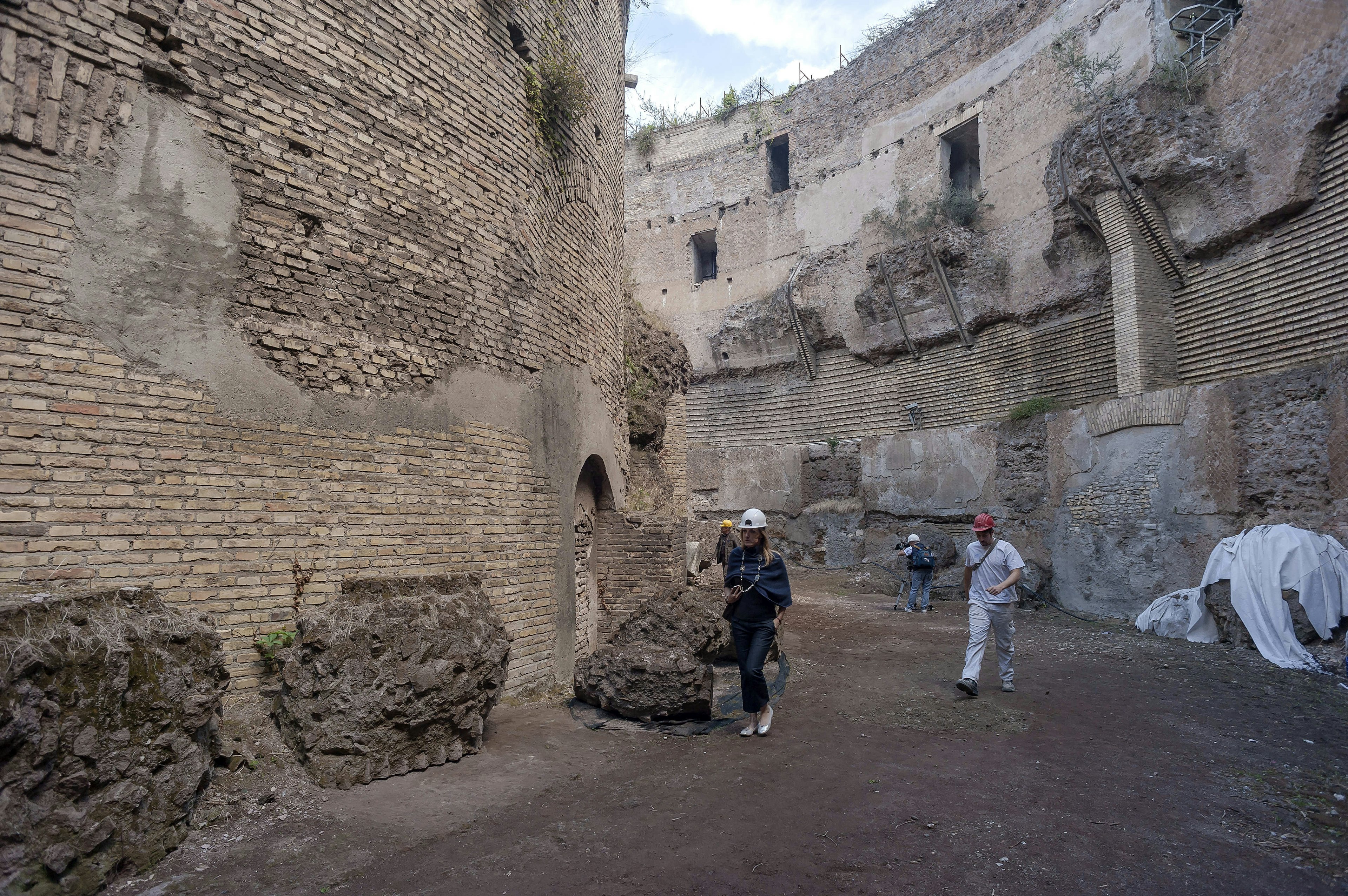 A picture of workers and archaeologists busy with restorations inside the Mausoleo