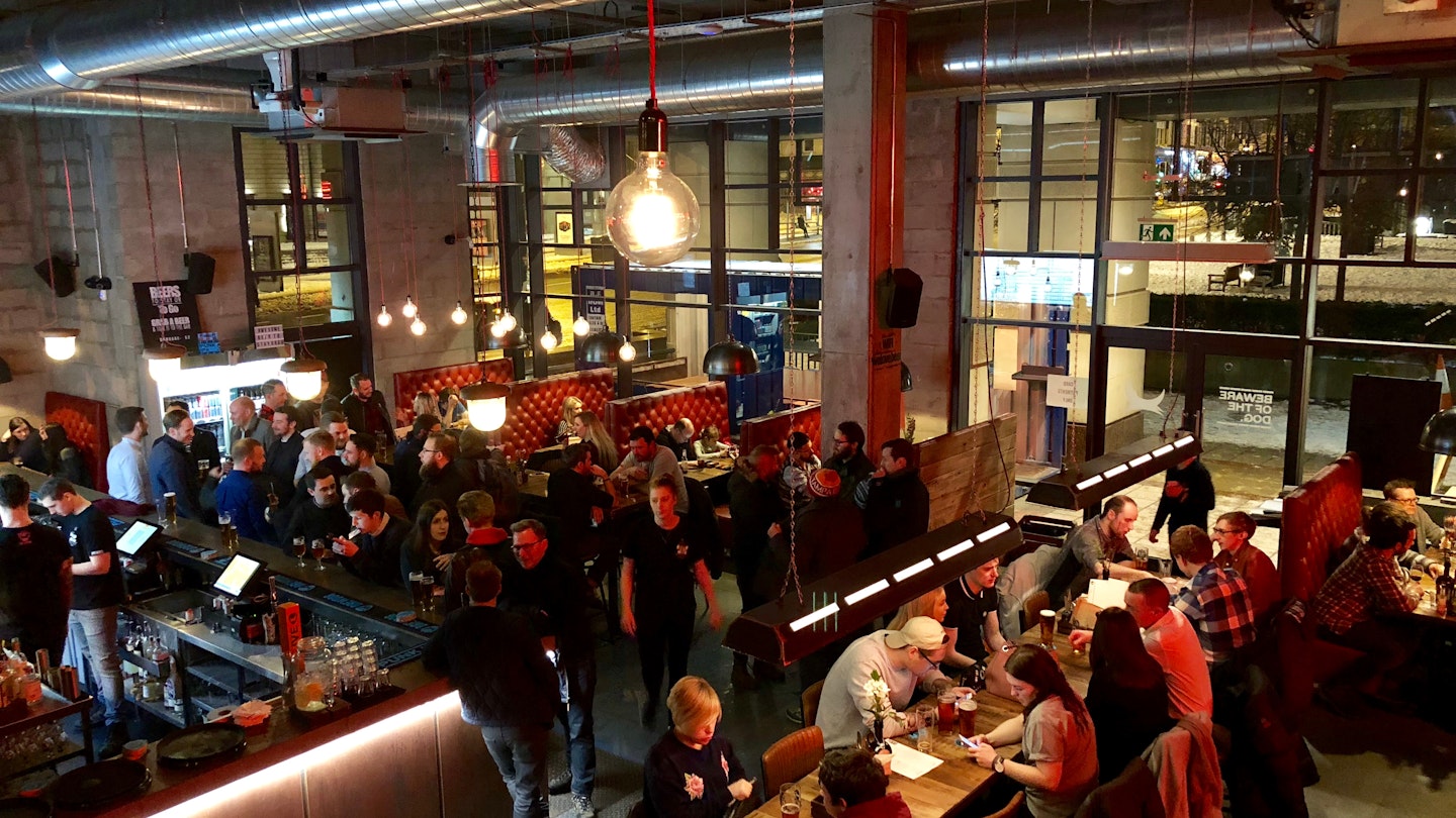 MARCH 3, 2018: Customers eat and drink inside Brewdog Lothian Road craft beer bar in Edinburgh.