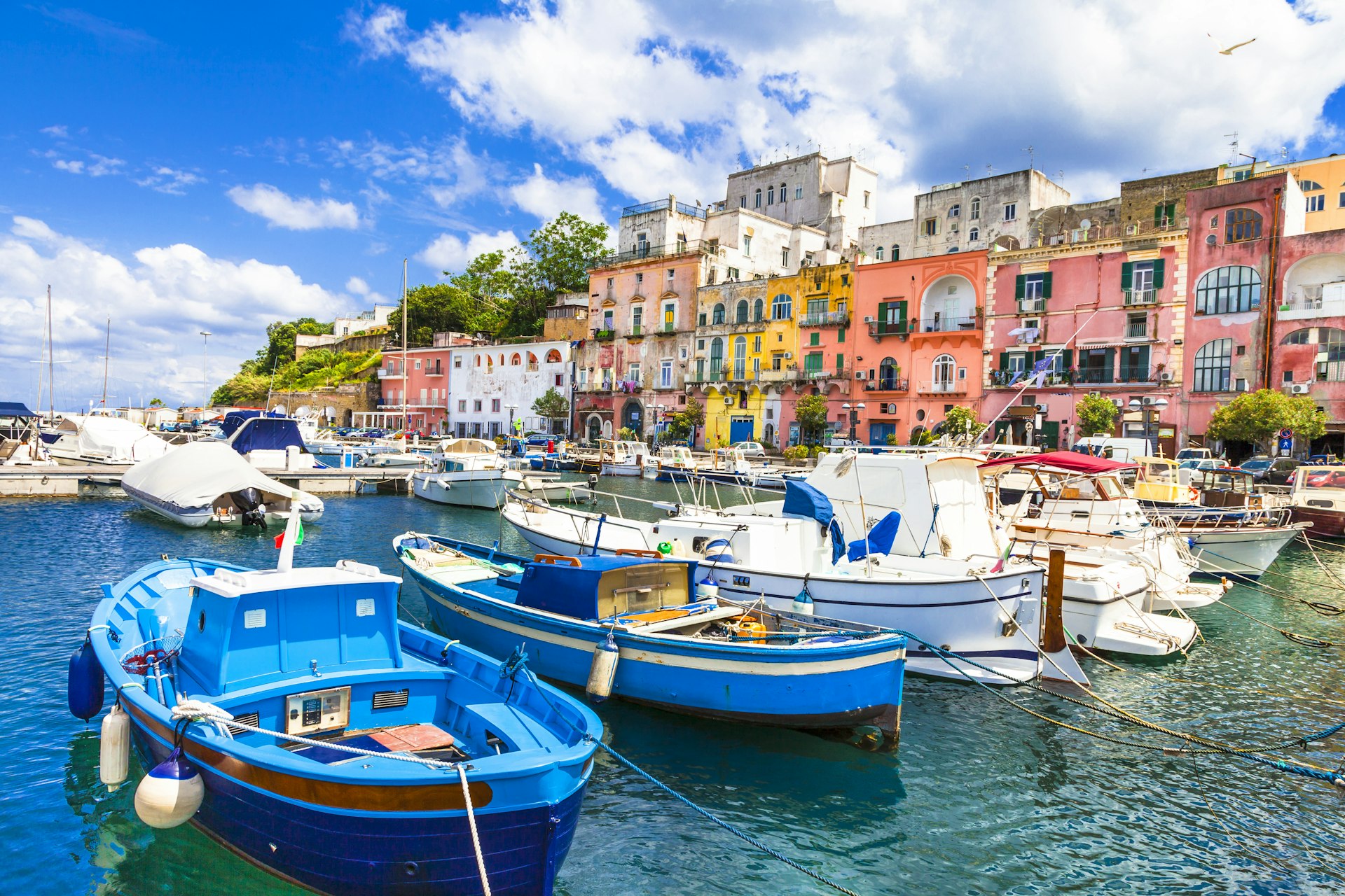 A picture of boats tied up in front of Procida's harbour