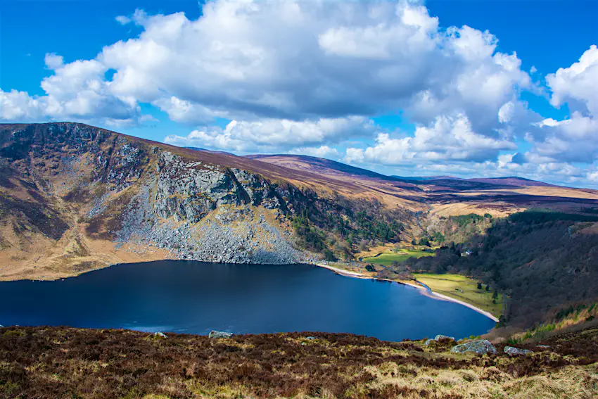 shutterstockRF_442467178.jpg Large white clouds hang over the Wicklow Mountains and below is the sparkling blue waters of Lough Tay