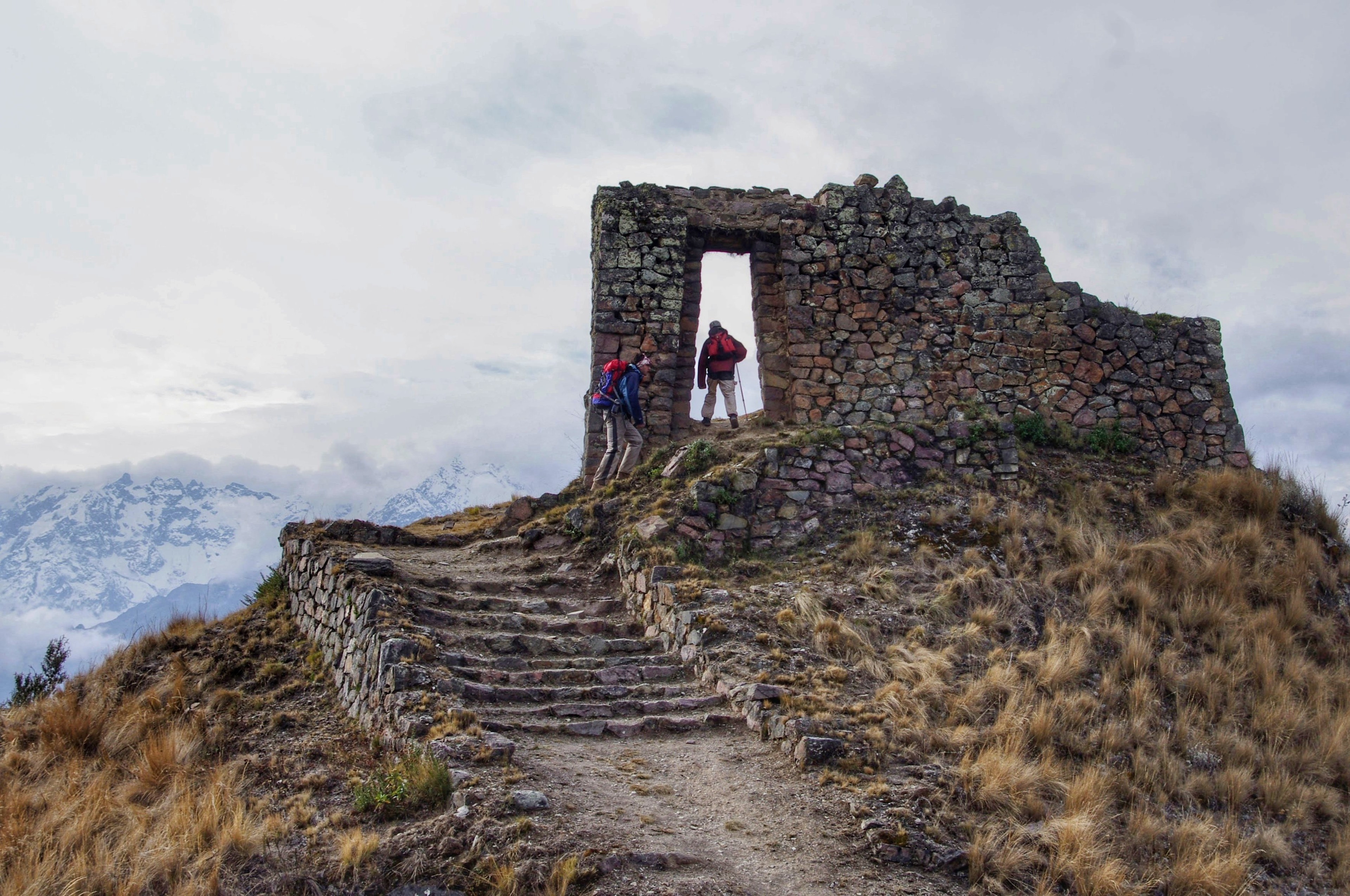 Hikers explore ruins in the Andes