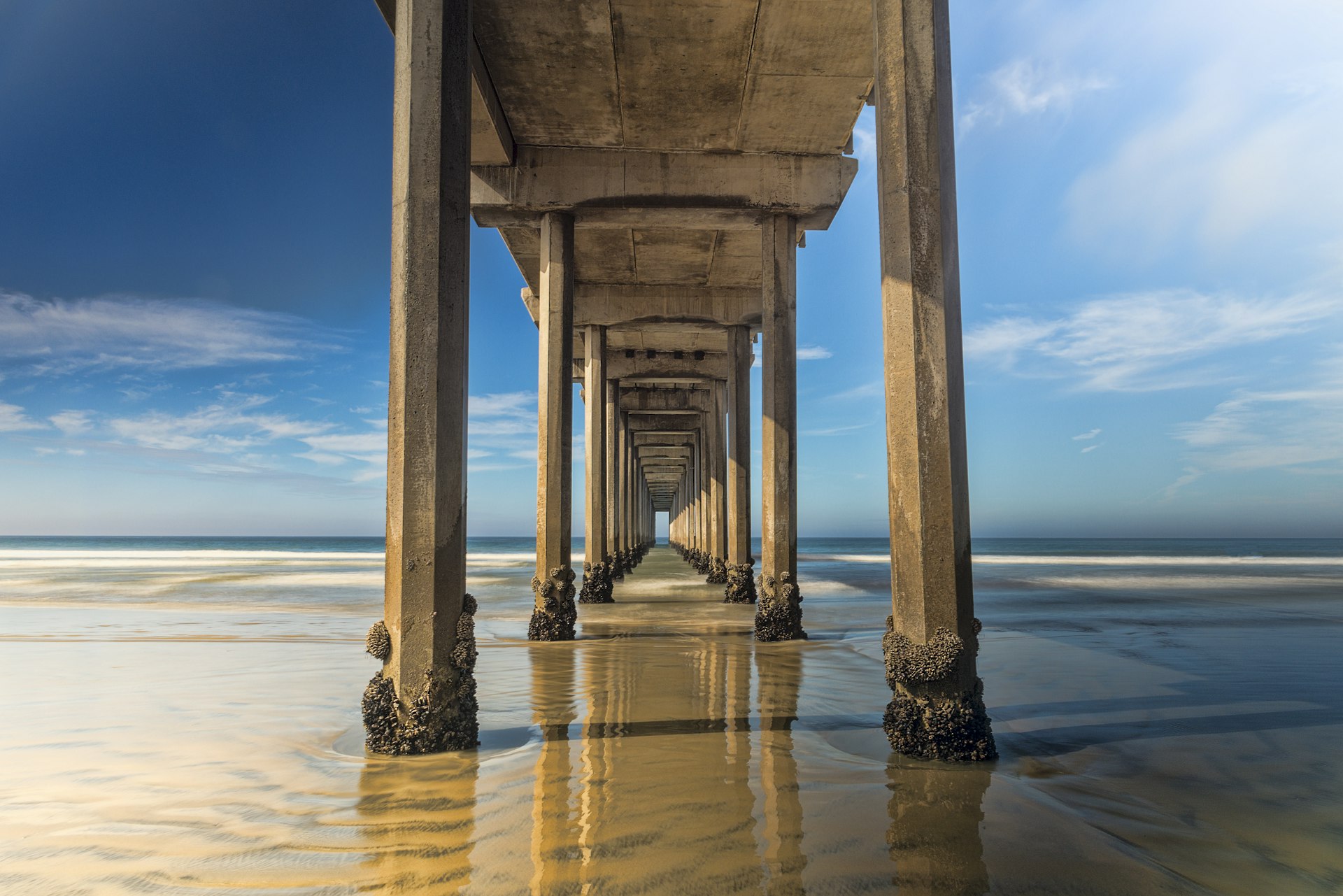 Looking out through the legs of Scripps Pier in La Jolla, California with the tide out