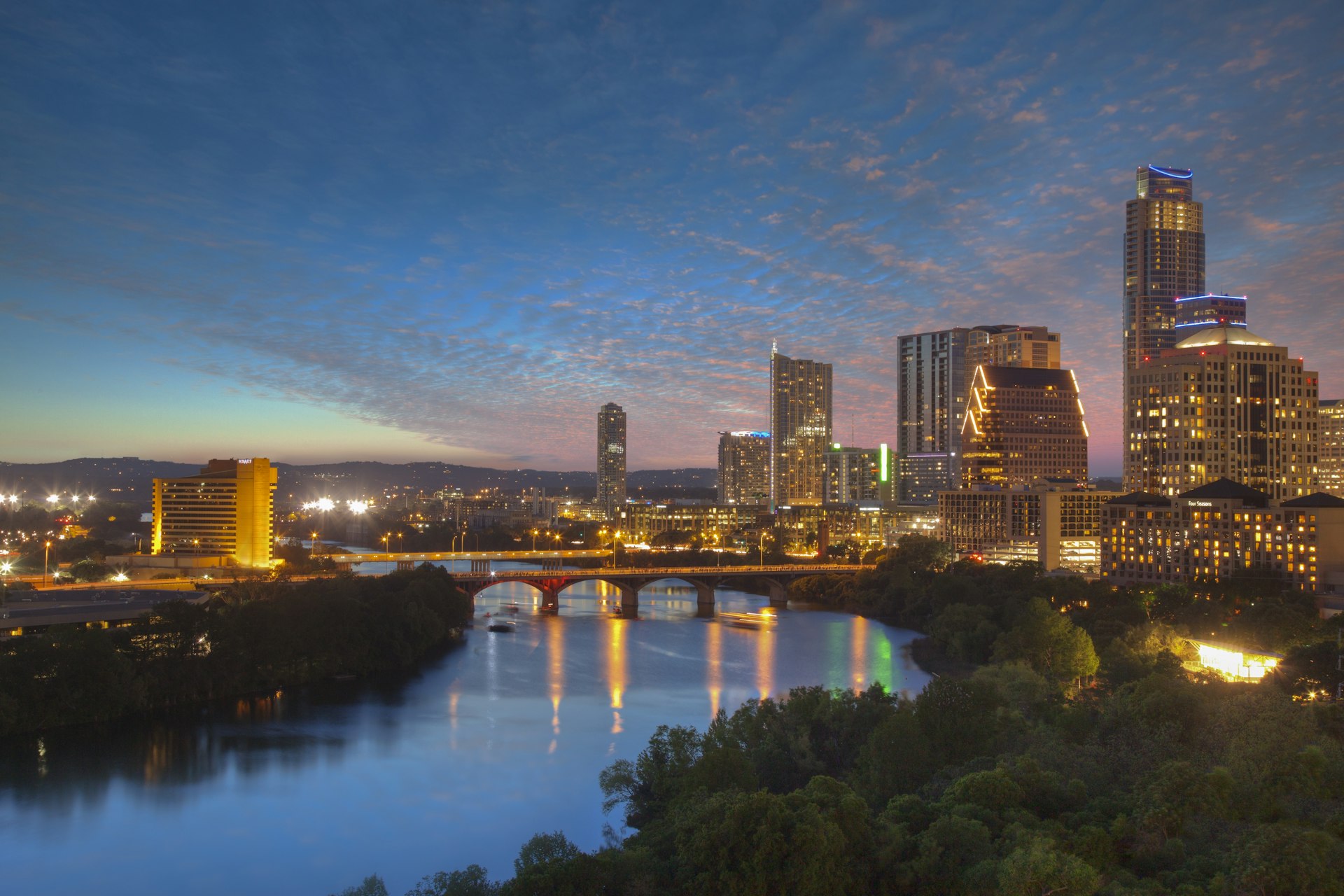 500px Photo ID: 95265045 - The Austin skyline on a wonderful April Evening rises above Lady Bird Lake and Zilker Park. Congress Bridge spans the river and connects the SoCo area with downtown.
