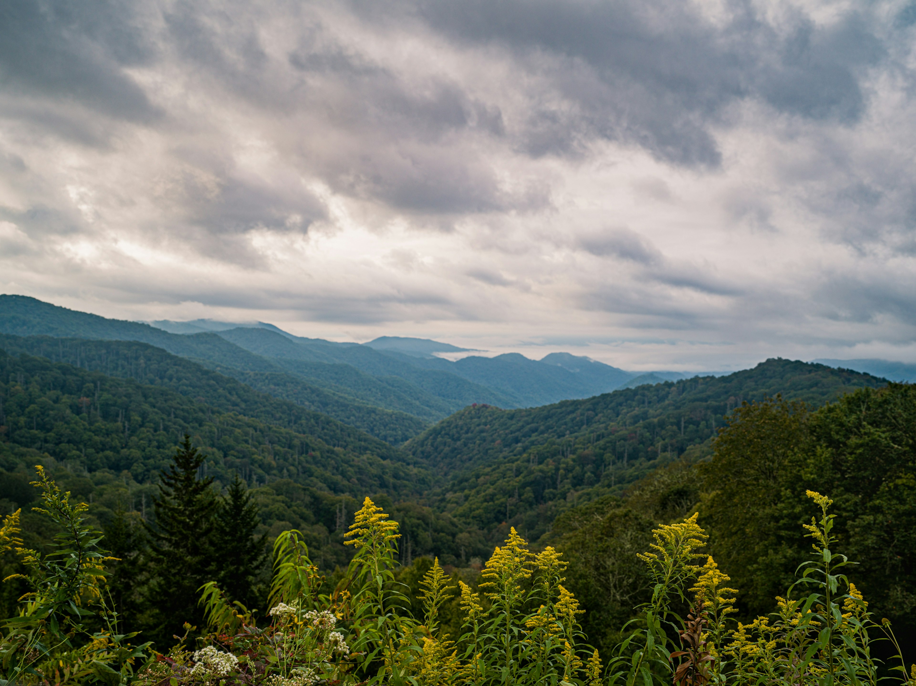 Green mountains under a cloudy sky