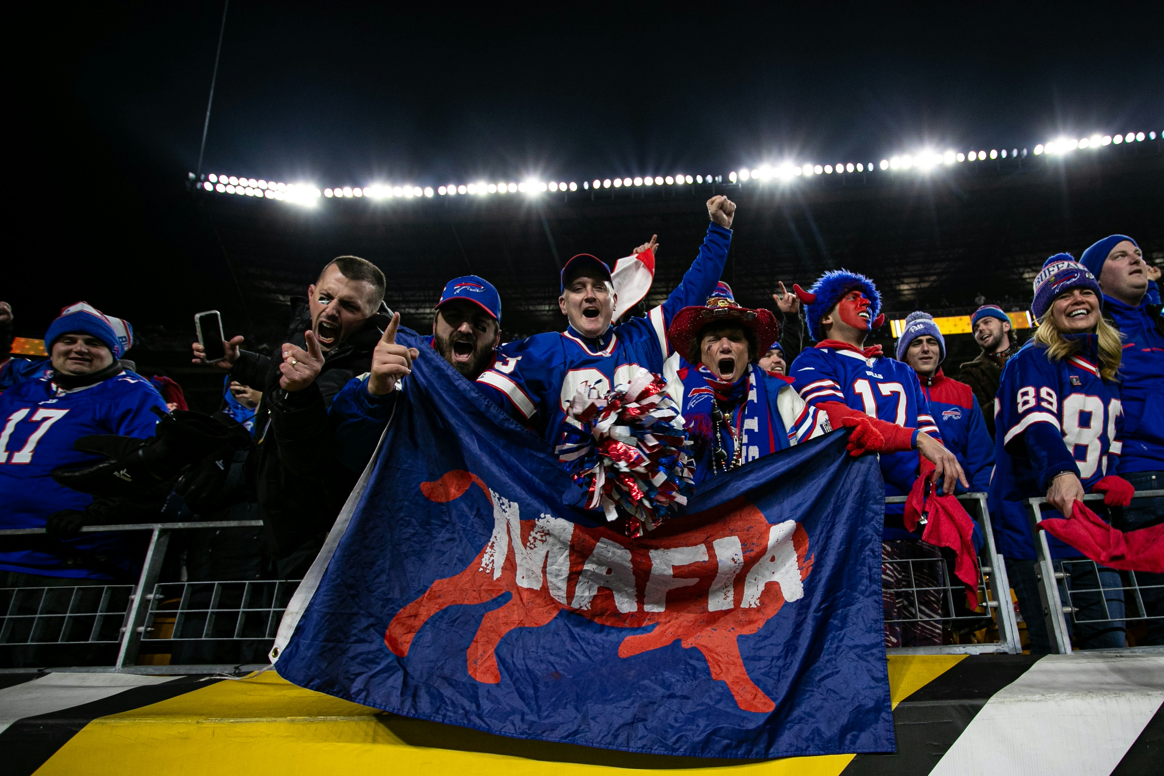 Bills Mafia fans hold a flag that says