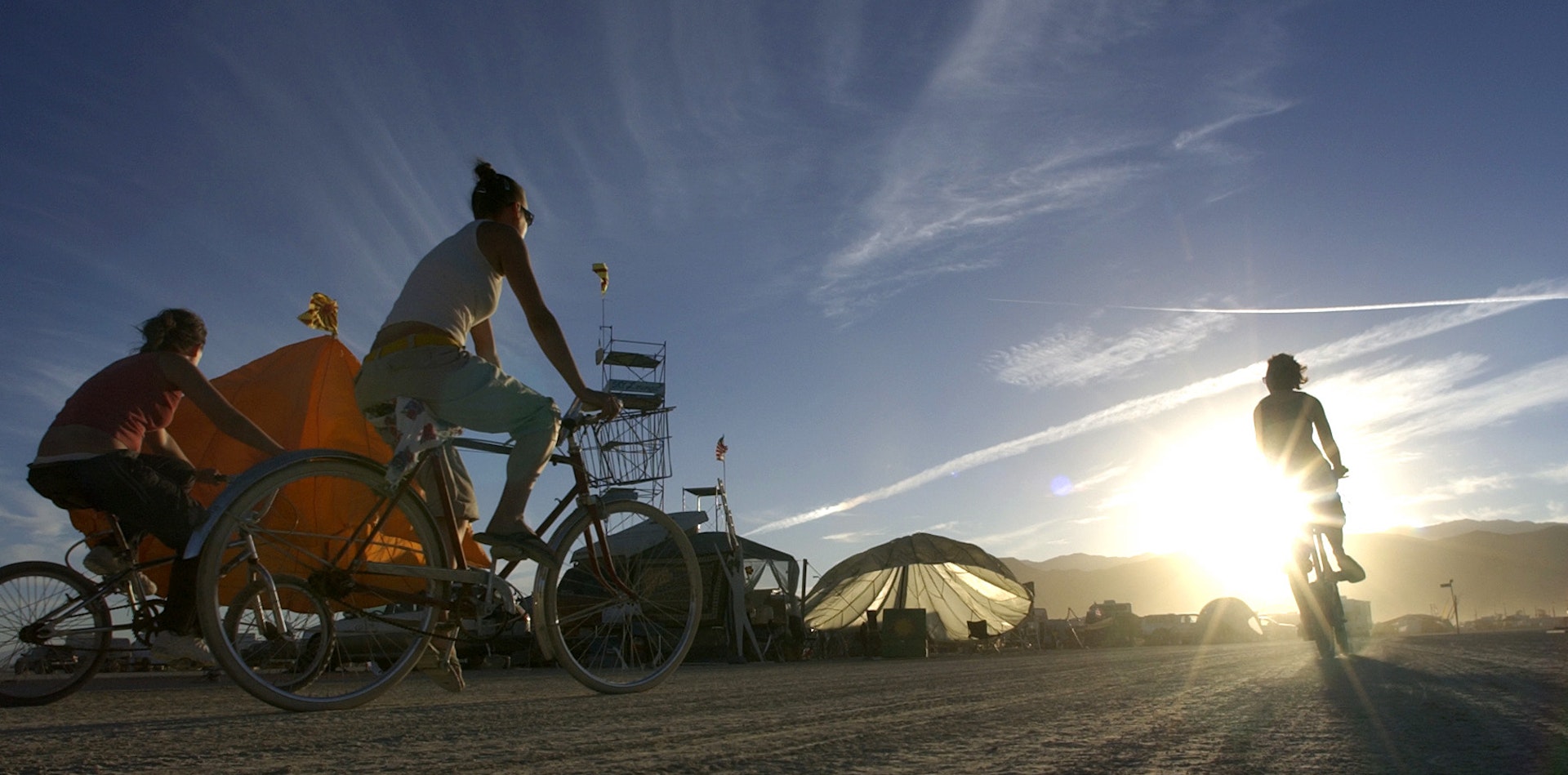 Cyclists ride through the desert on the eve of the official opening of Burning Man