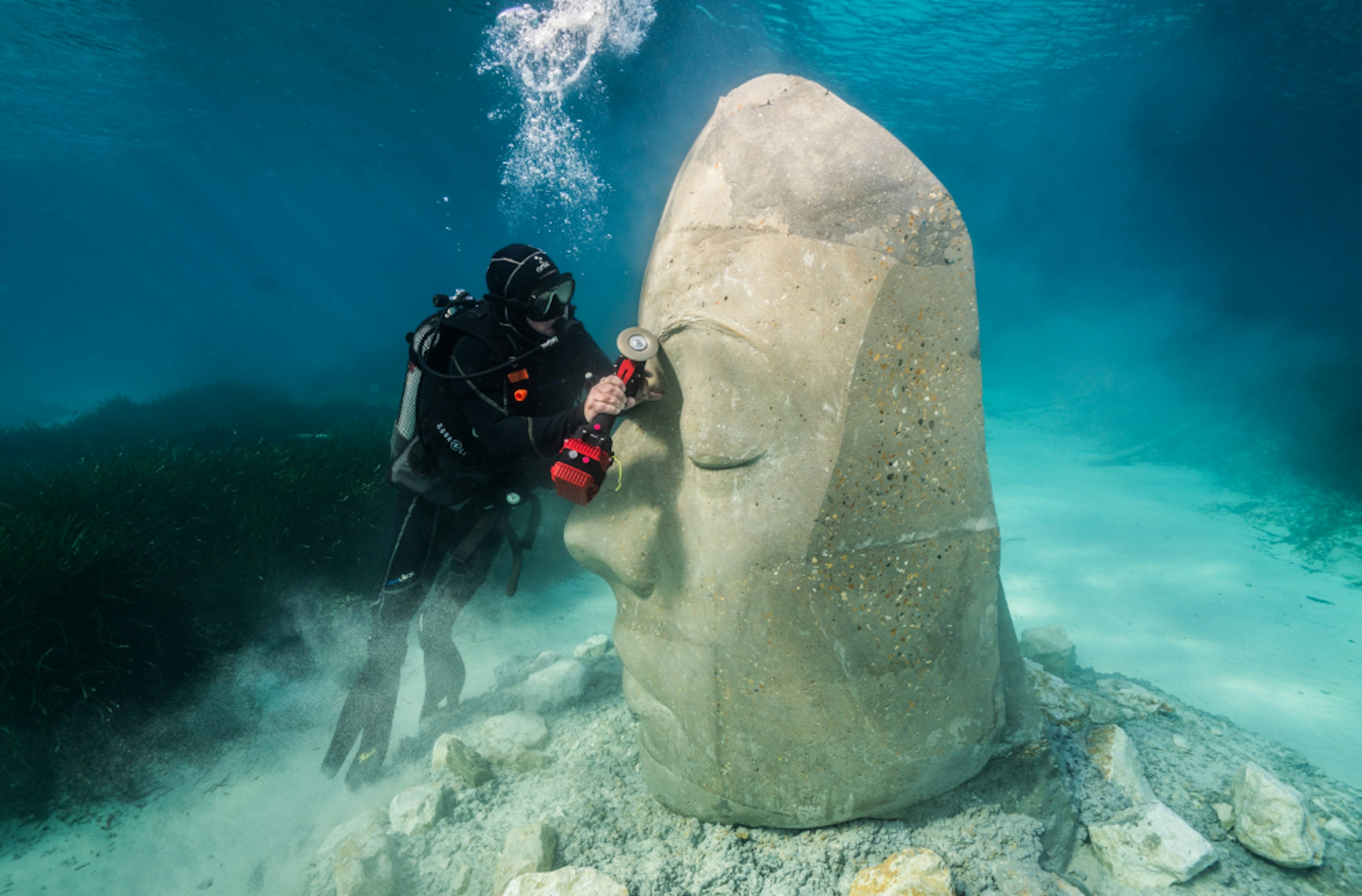 A diver working on a sculpture at the Cannes Underwater Museum